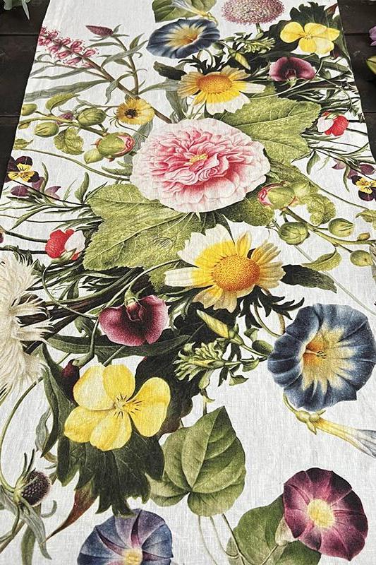 Floral table runner with colorful flowers on a wooden surface