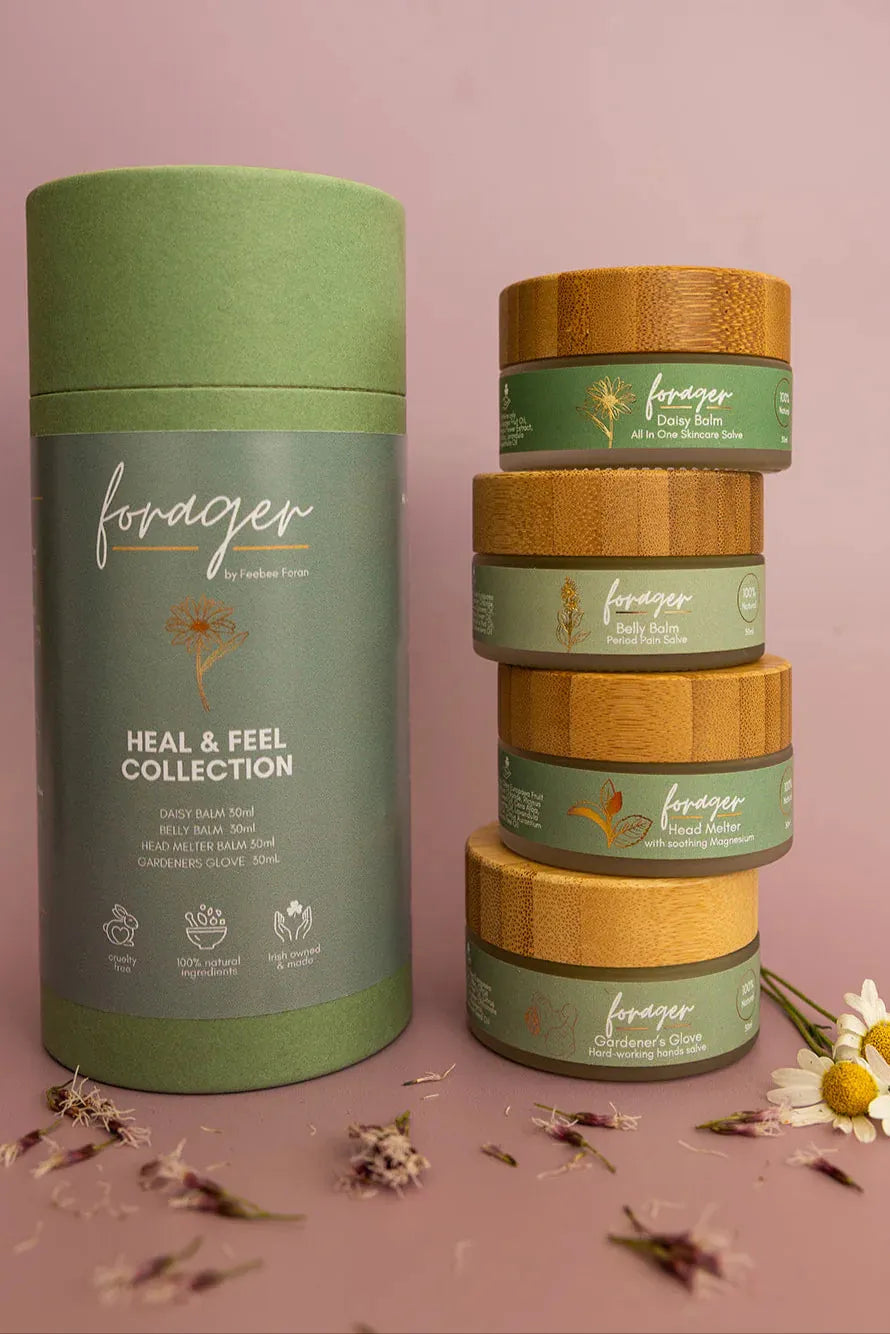 Forager Heal and Feel collection skincare balms with daisy, belly, head melter, and gardener's glove jars.