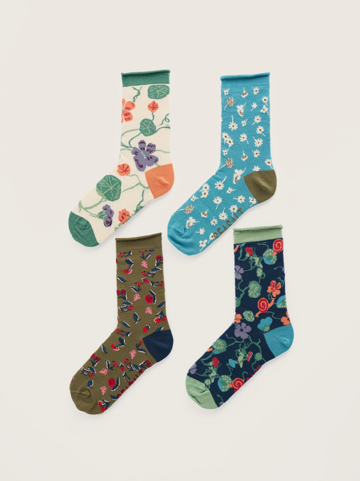 Four pairs of Seasalt Cornwall women's cotton socks with floral and nature-inspired patterns.