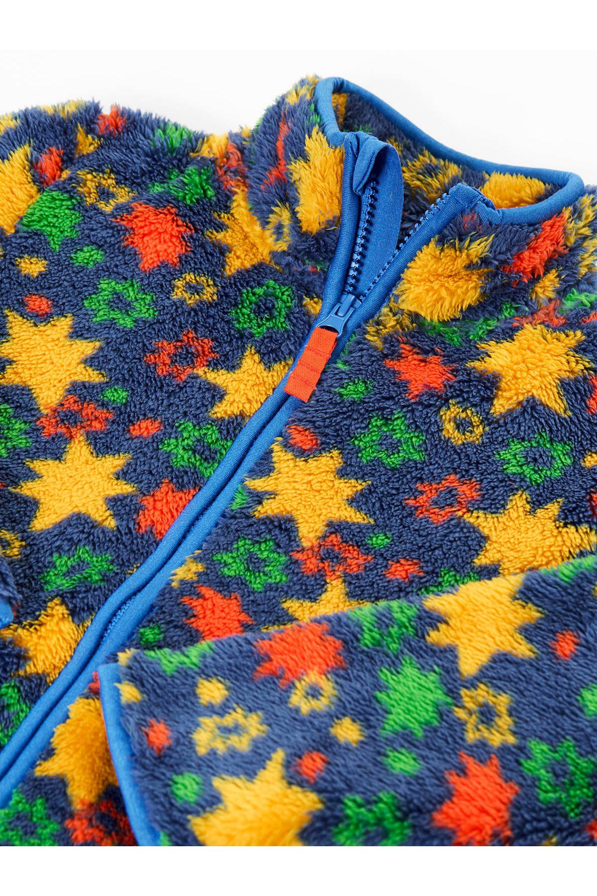 Close-up of a Frugi boys fleece jacket with a vibrant star pattern made from recycled polyester.