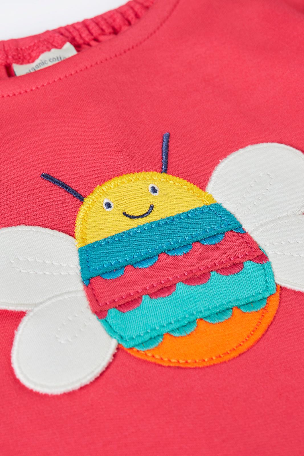 Children's Frugi t-shirt with a colorful bee design on a pink background