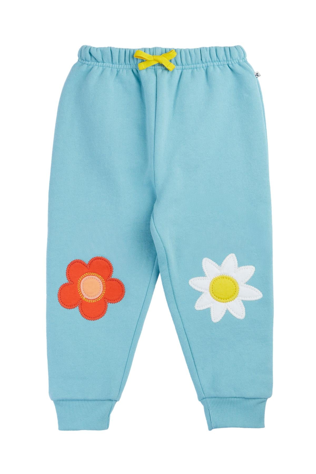 Light blue children's pants with flower appliqués on a white background