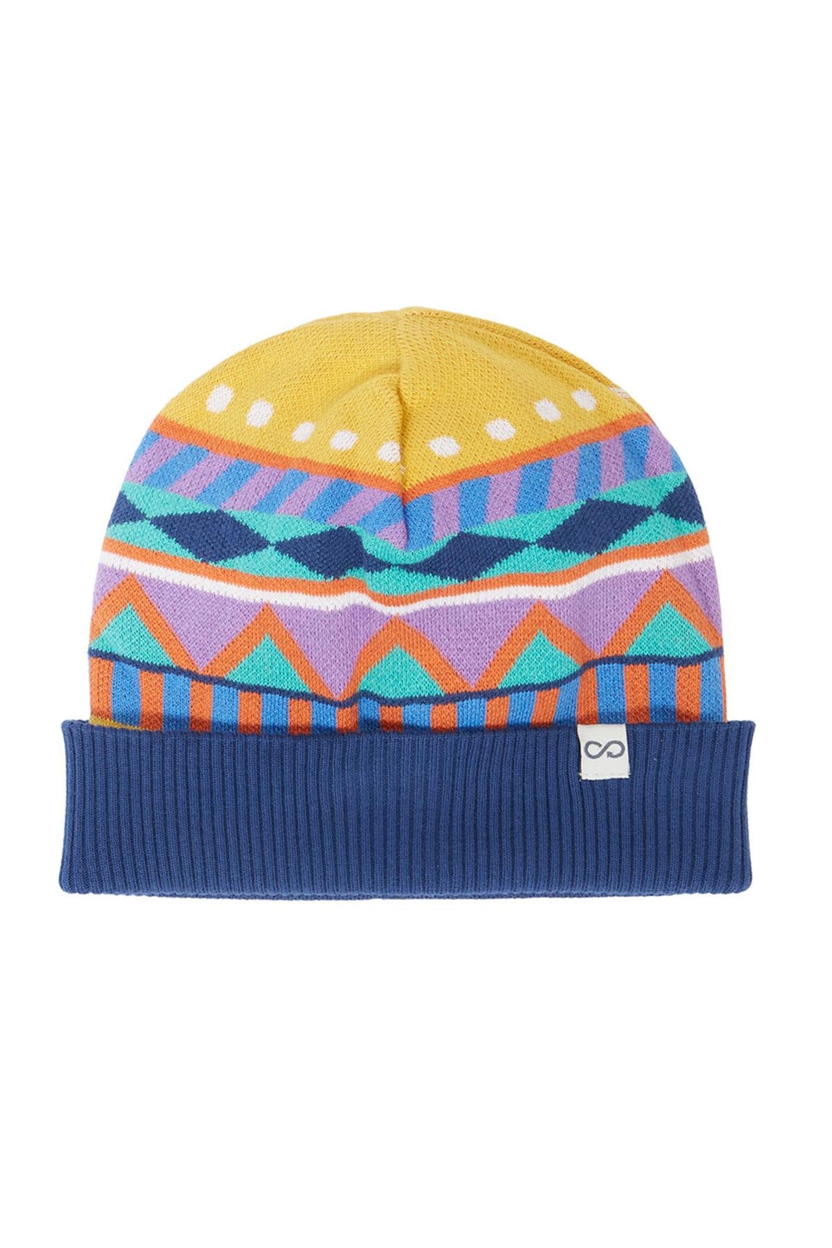 A colorful Frugi knit beanie hat with geometric tribal patterns and a solid navy blue brim on a white background
