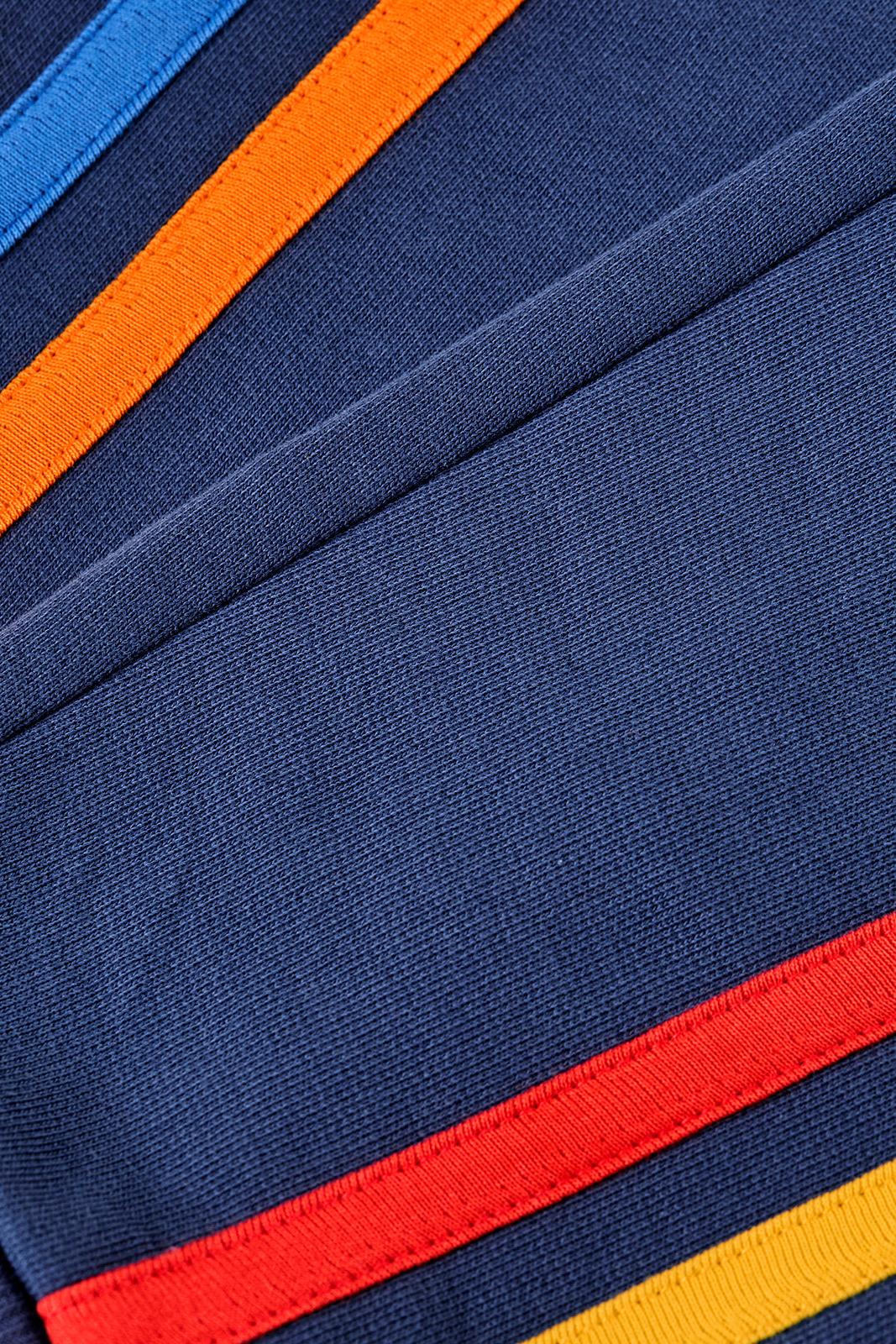 Close-up of organi cotton fabric with blue background and multicolor stripes