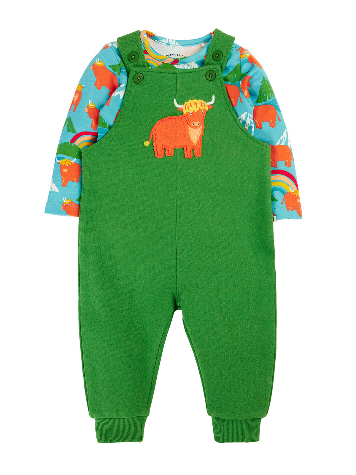 A baby's long-sleeve footless overalls romper in bright green, featuring a colorful cartoon Scottish Highland cow on the chest and a light blue patterned long-sleeve shirt underneath.