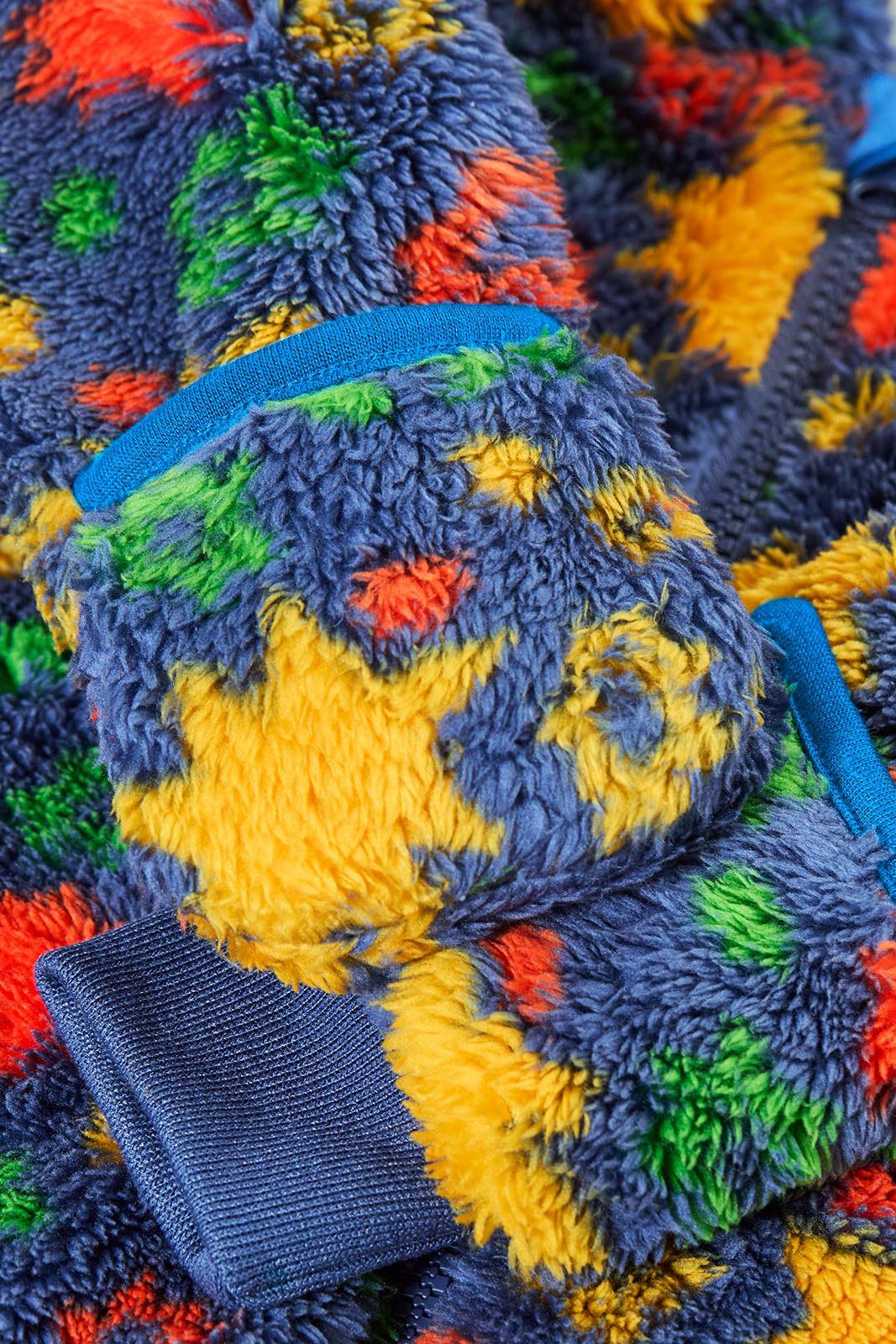 Close up of a colourful Frugi baby pramsuit made from recycled polyester fleece.