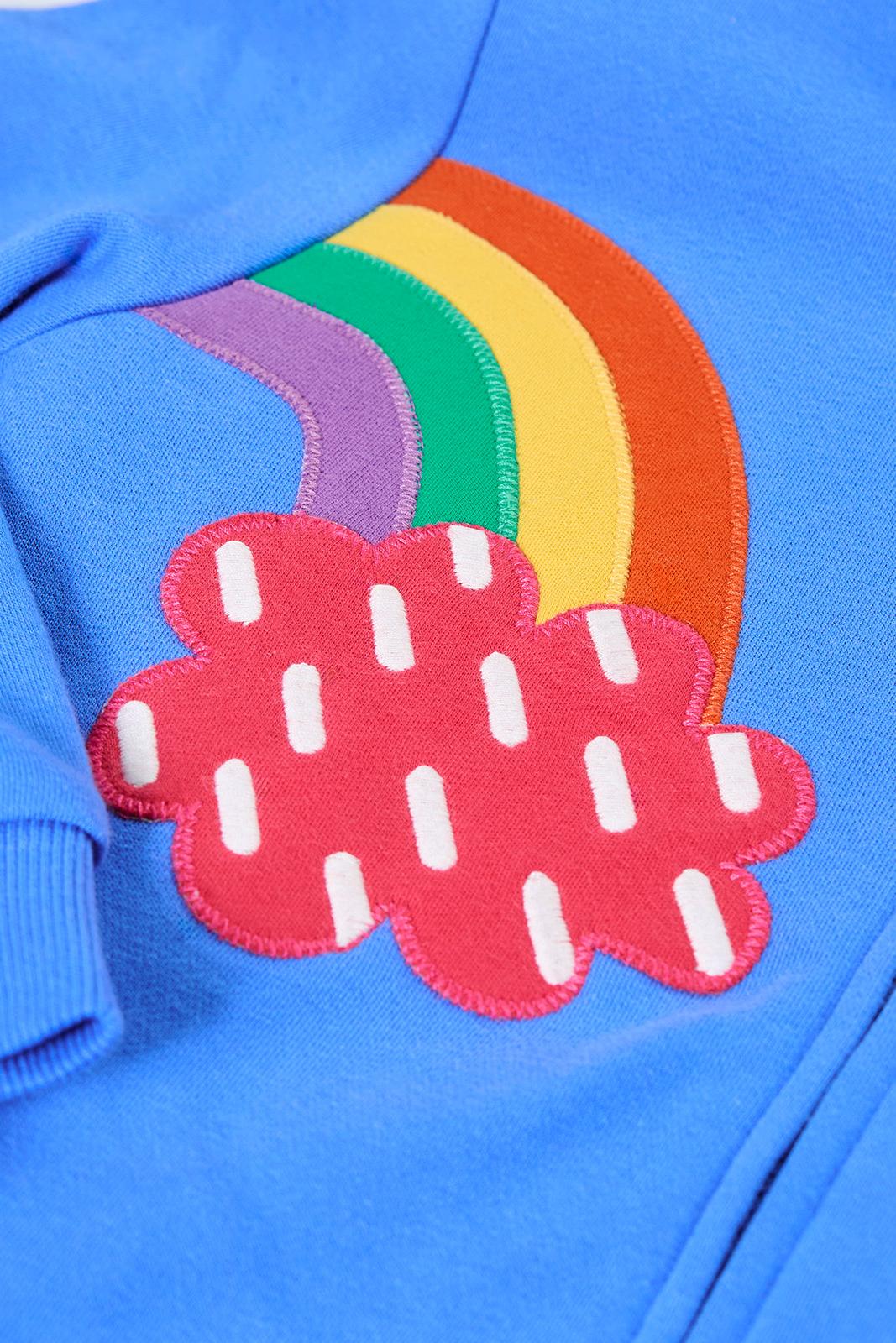 Close-up of a Frugi girls jumper featuring a colourful rainbow and red rain cloud appliqué design.