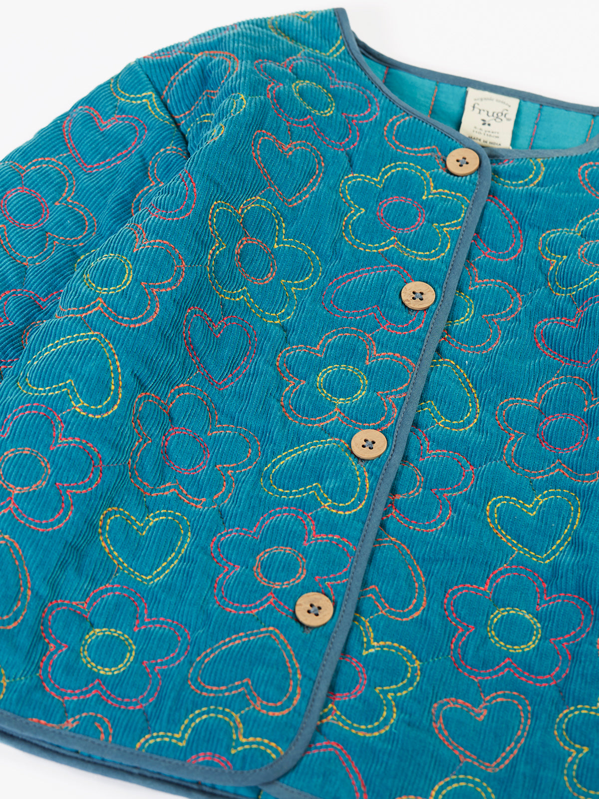 Teal Frugi organic cotton cord jacket with colorful embroidered heart and flower patterns.