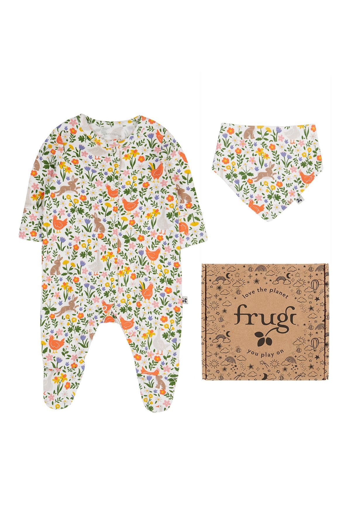Frugi babygrow with floral pattern, matching bib, and 'frugi' packaging on a white background
