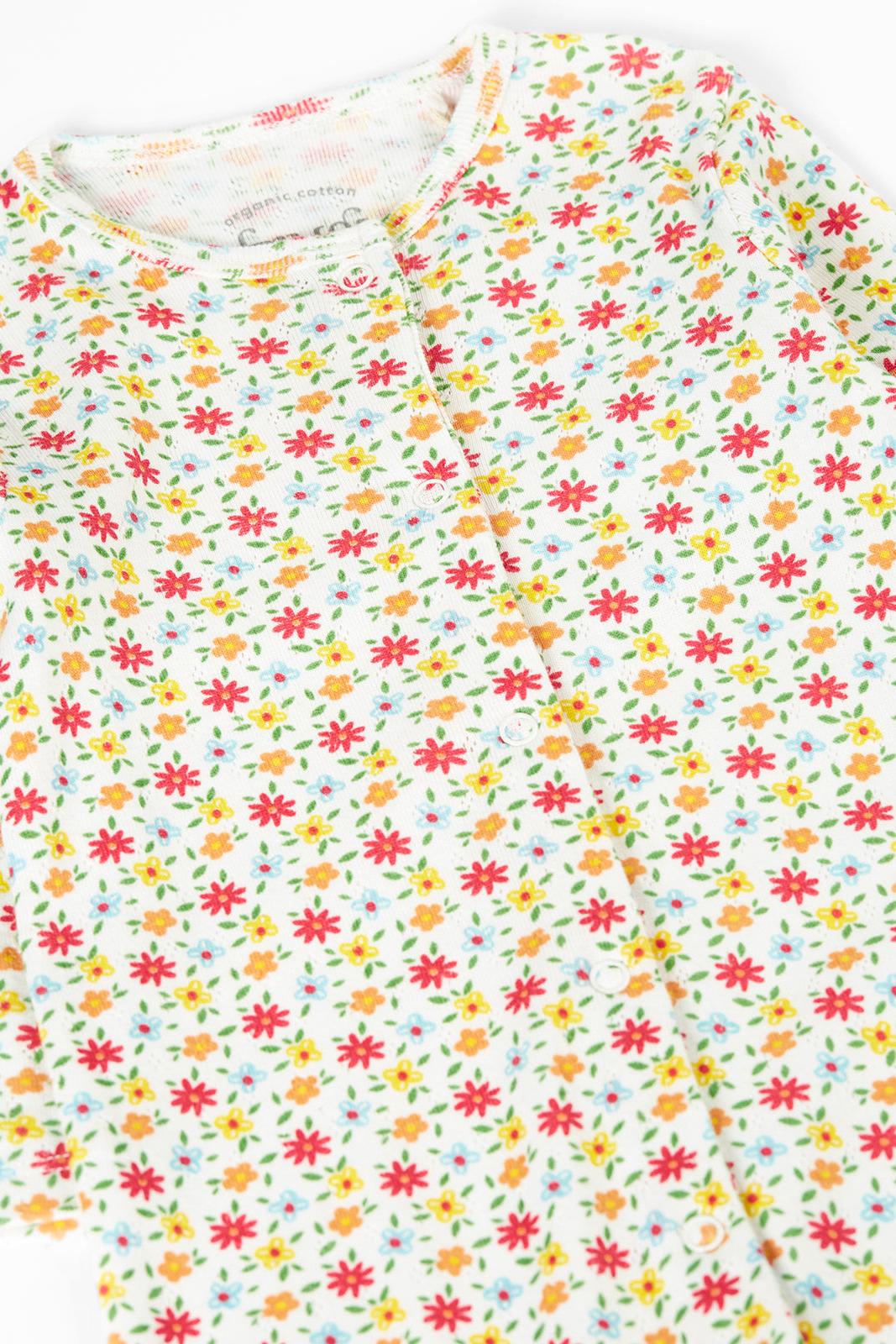 Floral patterned fabric with small red and yellow flowers on a white background