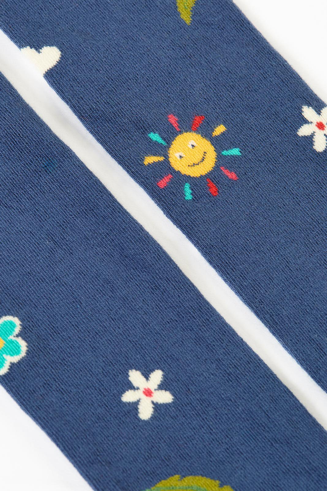 Oorganic cotton tights with sun and flower patterns on a white background