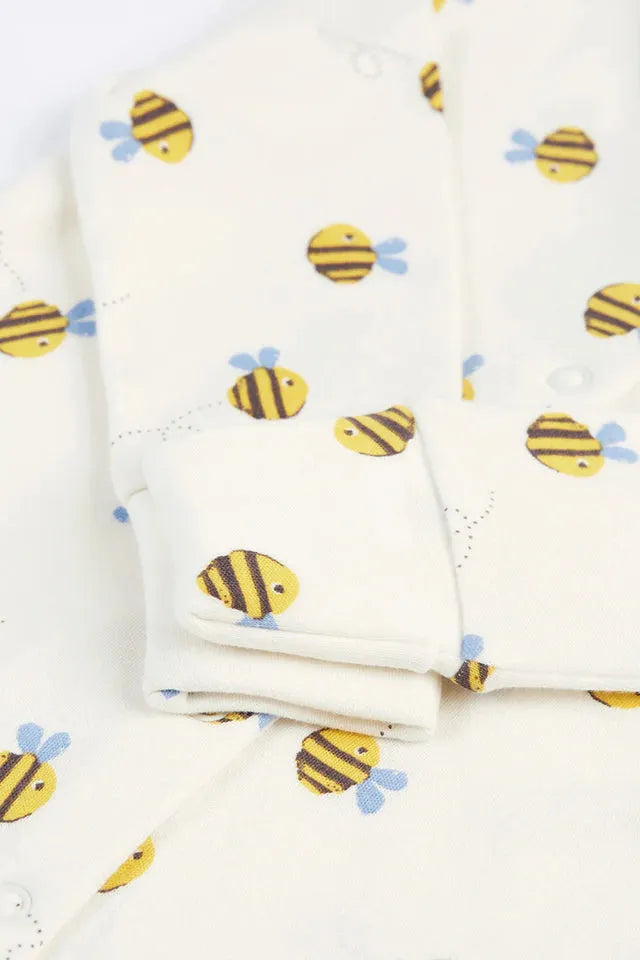 Close-up of a Frugi organic cotton baby onesie featuring a yellow and black bumblebee print pattern