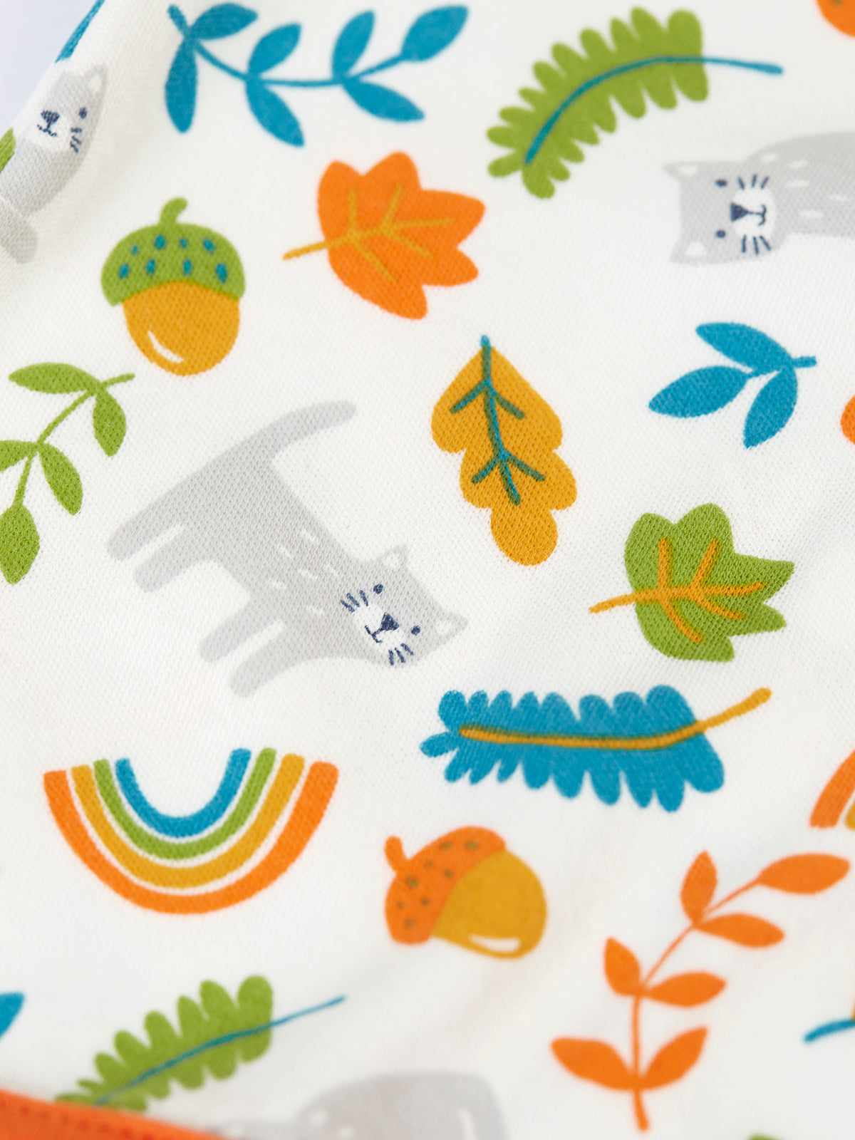 Close-up of Frugi organic cotton babygro featuring a colorful forest animal and leaf print.