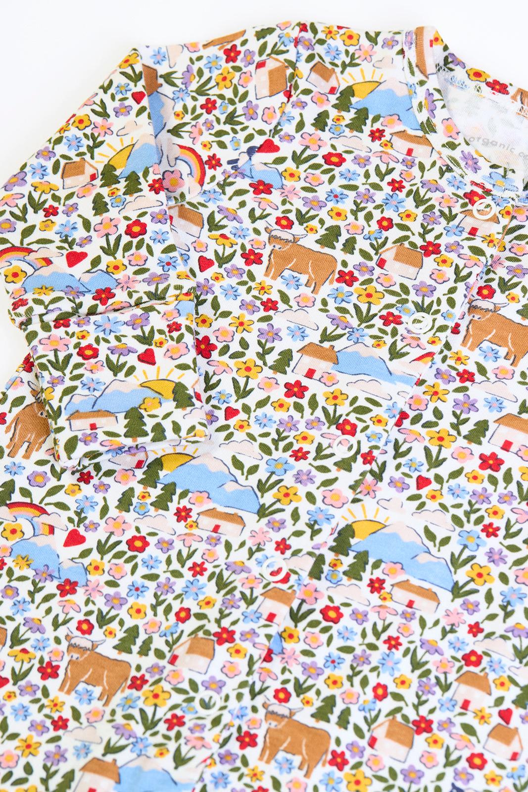 Frugi organic cotton babygro with a colorful floral and highland cow print for a new baby.