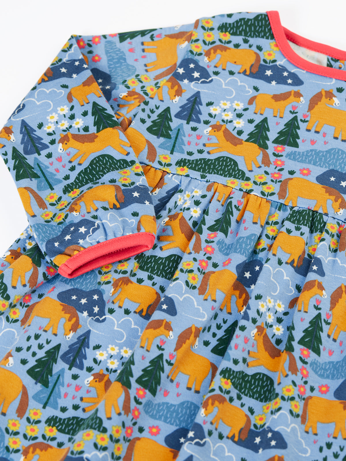 Frugi girls long-sleeve dress in blue organic cotton with a whimsical horse, tree, and flower pattern.