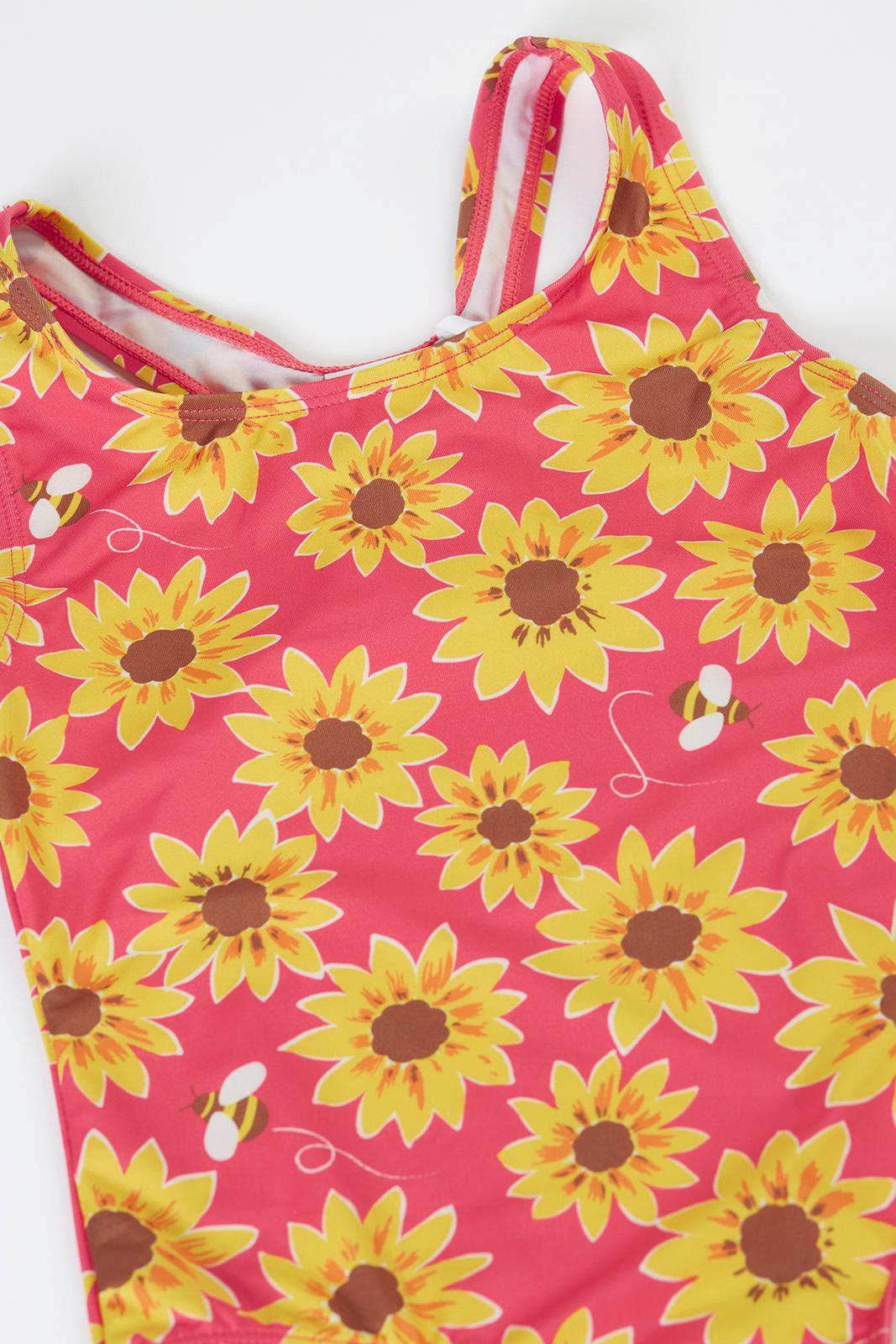 Frugi children's swimsuit featuring a vibrant pink background with a yellow sunflower and bee print.