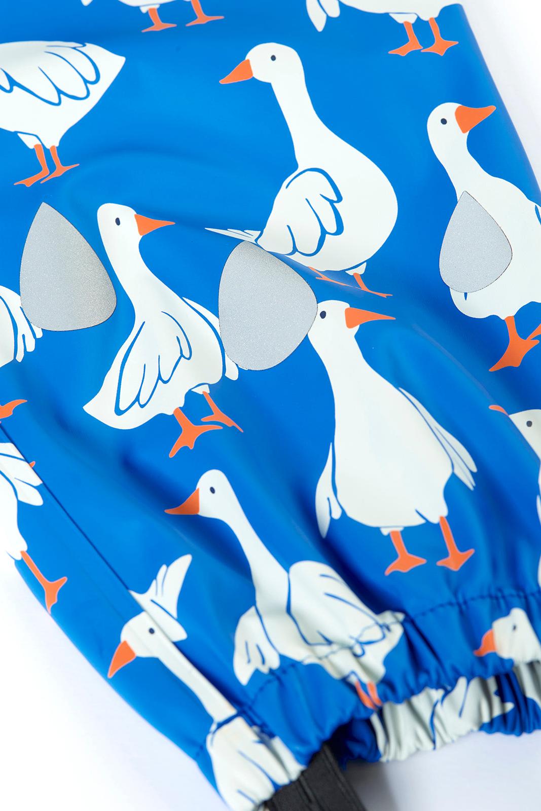 Blue Frugi rain trousers with white geese pattern on a white background