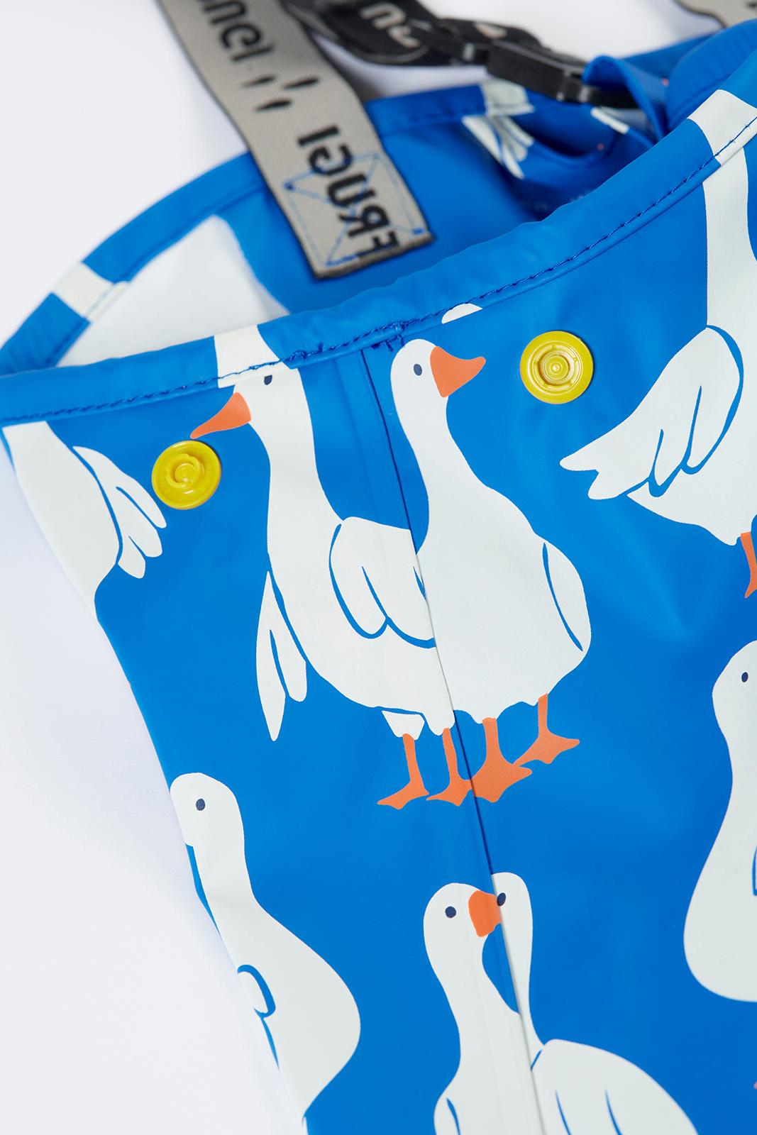 Blue trousers with white goose pattern and yellow buttons on a white background