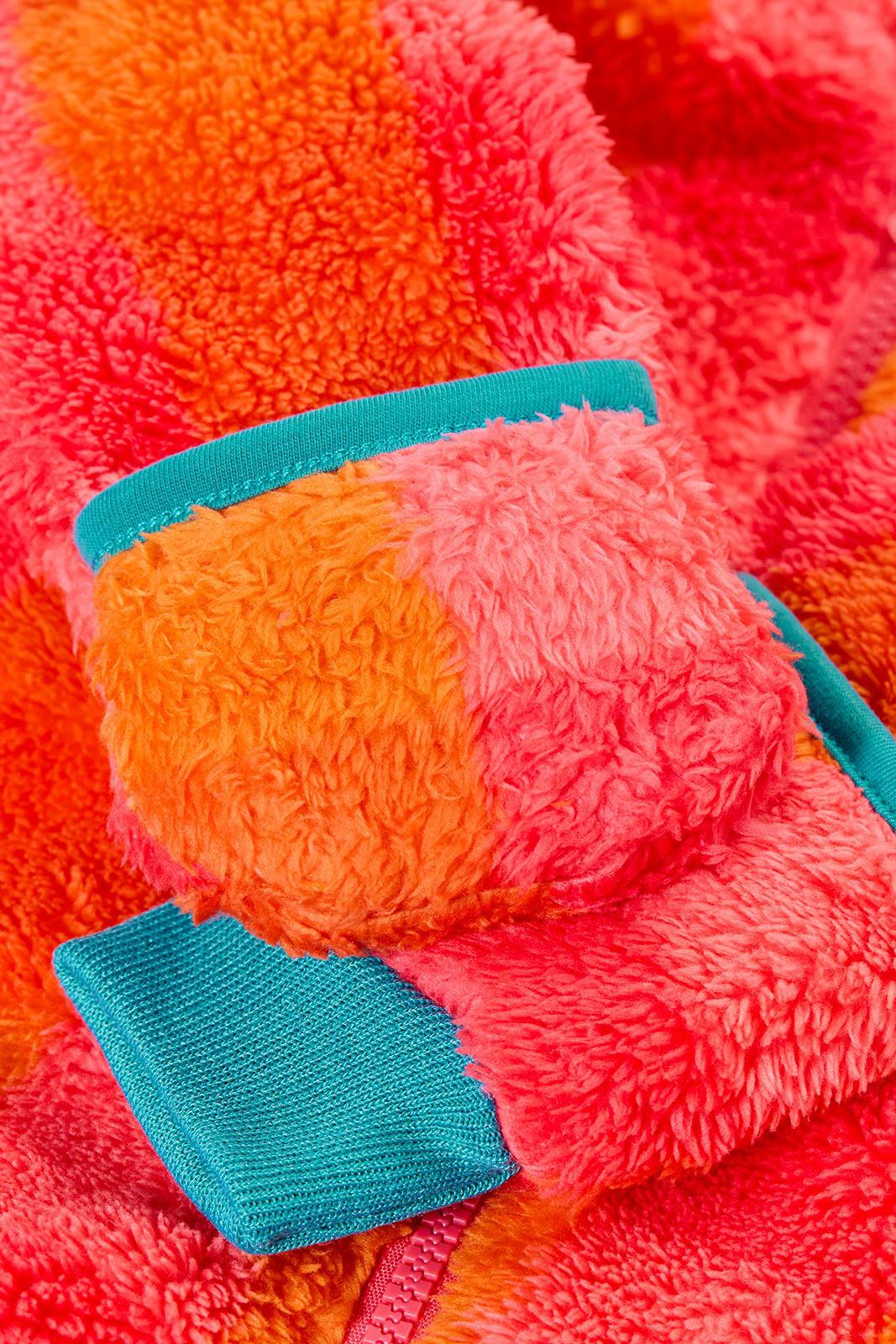 Close-up of a colourful Frugi baby snuggle suit made from recycled polyester fleece.