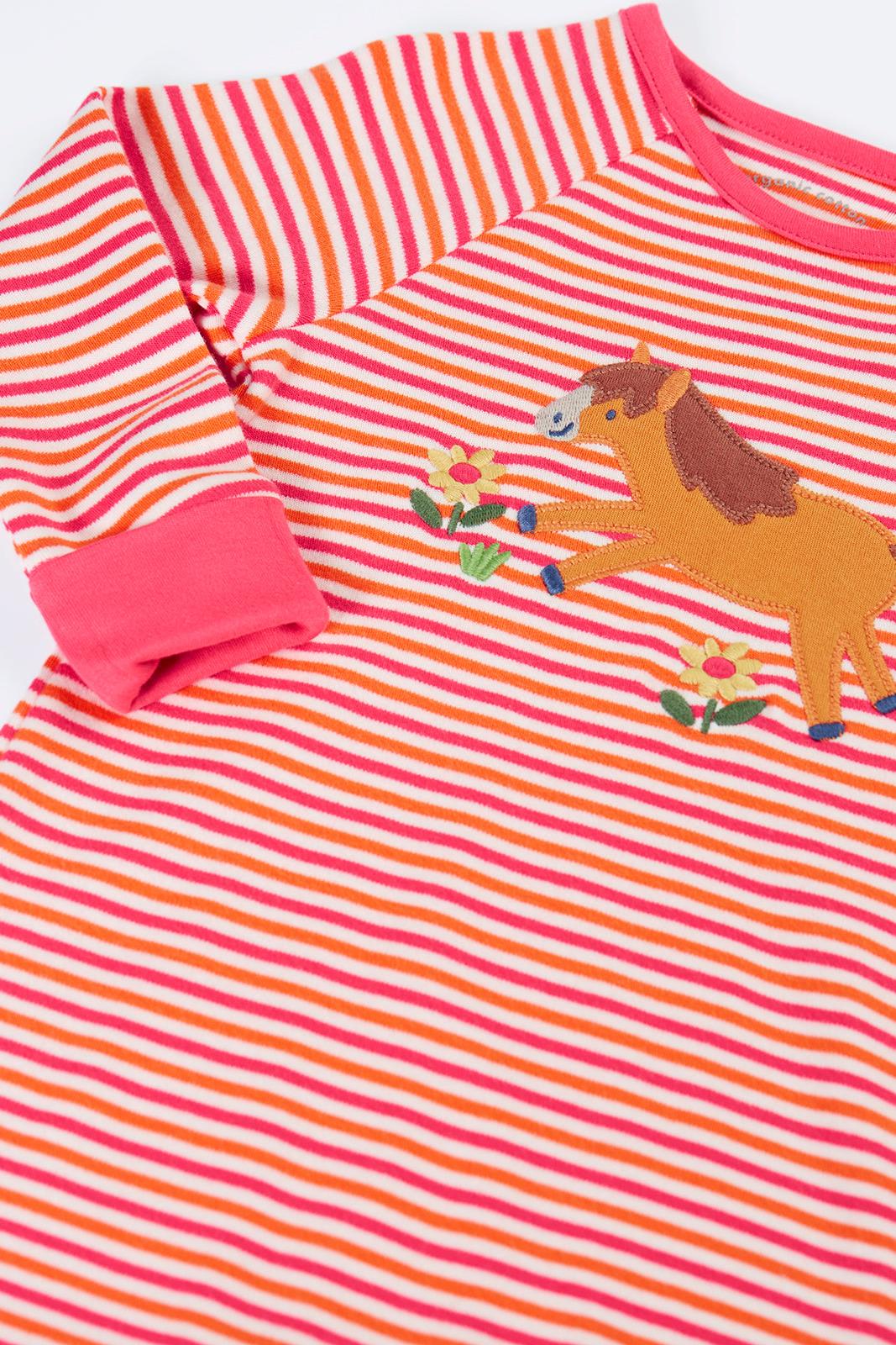 A Frugi baby jumpsuit featuring a horse applique on a pink and orange striped organic cotton fabric.