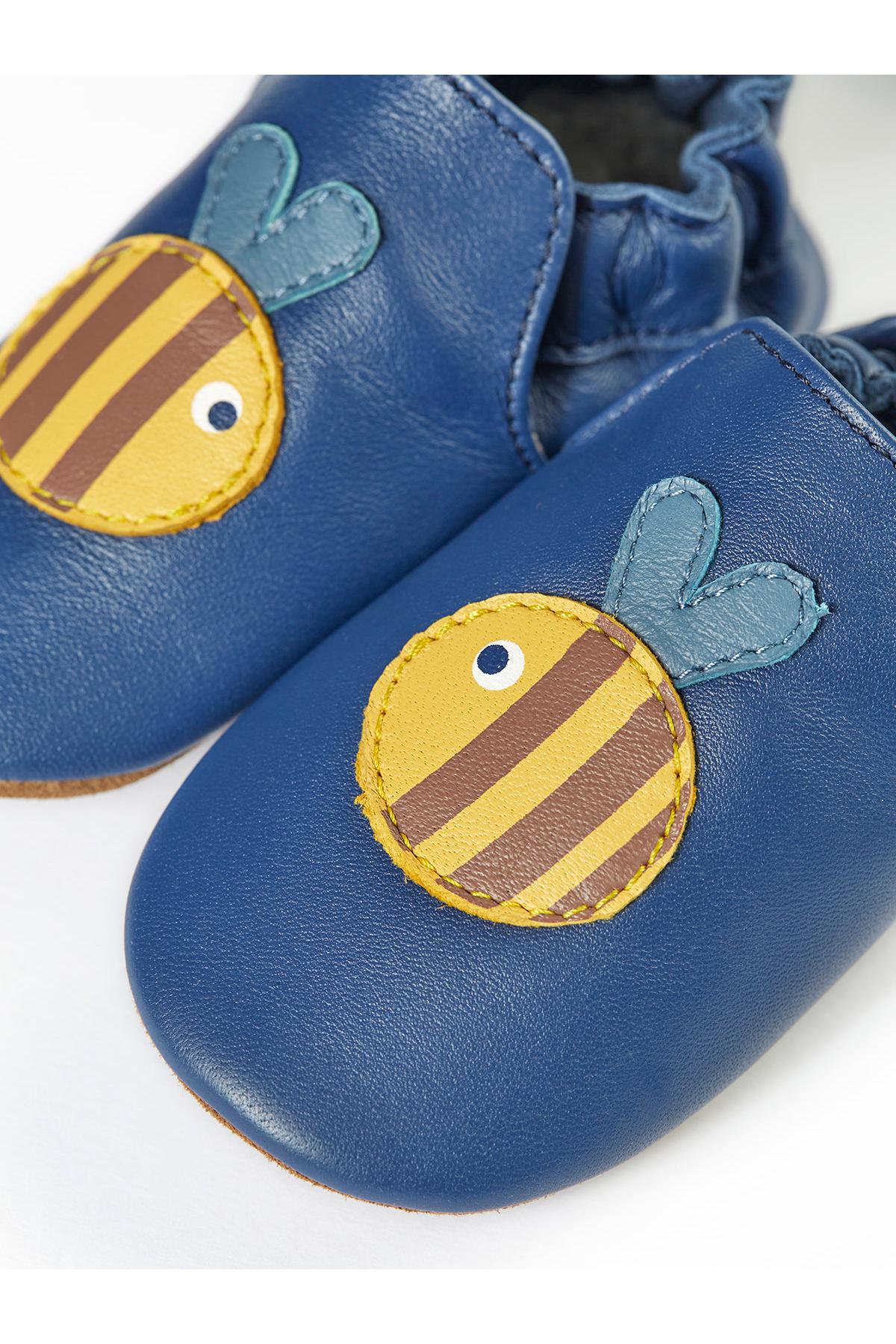 Blue baby shoes with bee design on a white background