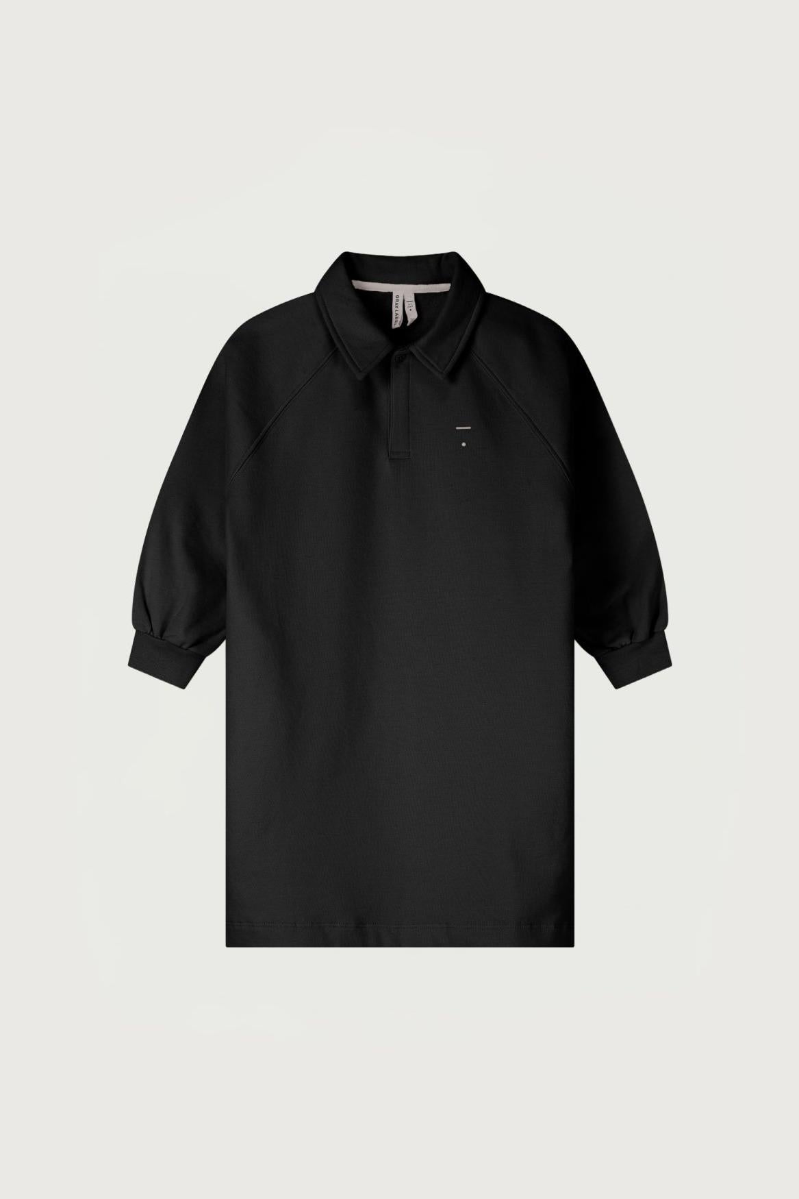 A black long-sleeve polo shirt with a small embroidered logo on the left chest, displayed against a light gray background.