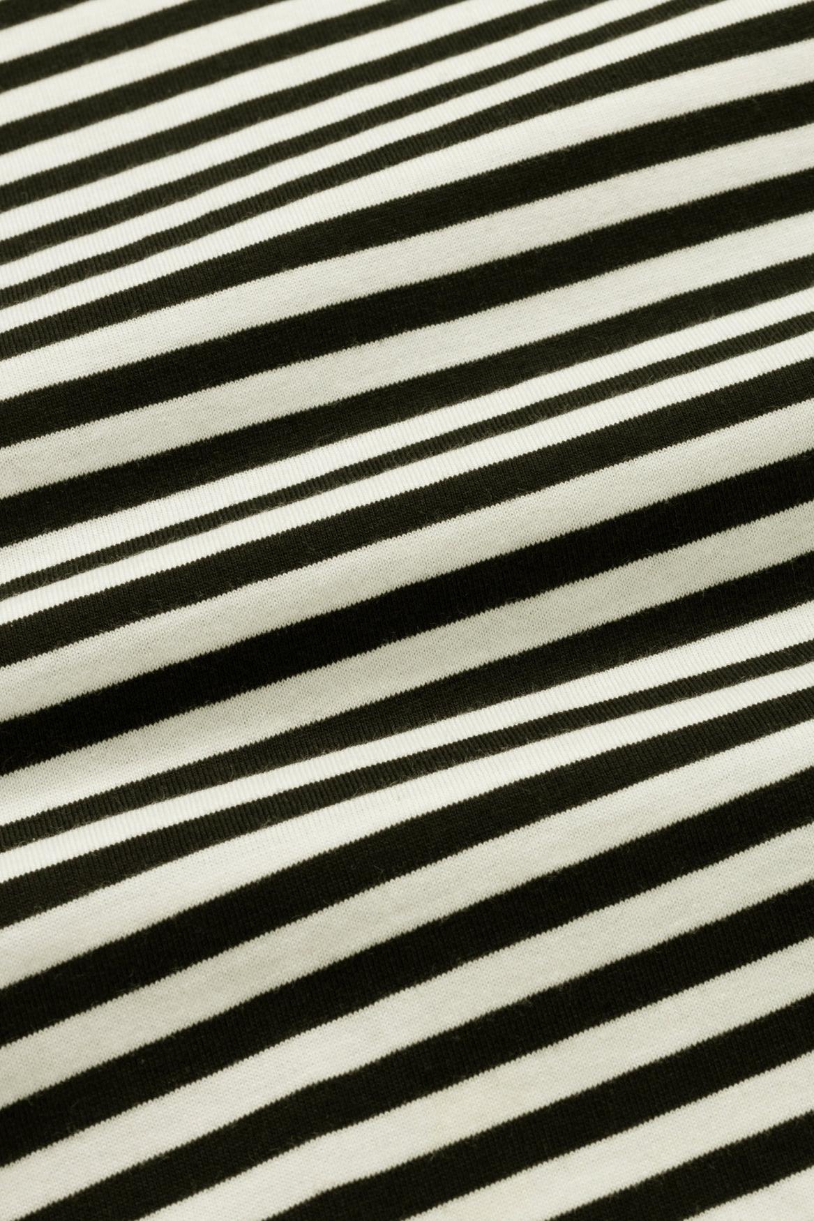 A close-up of a black and off-white striped fabric with a soft, plush texture.