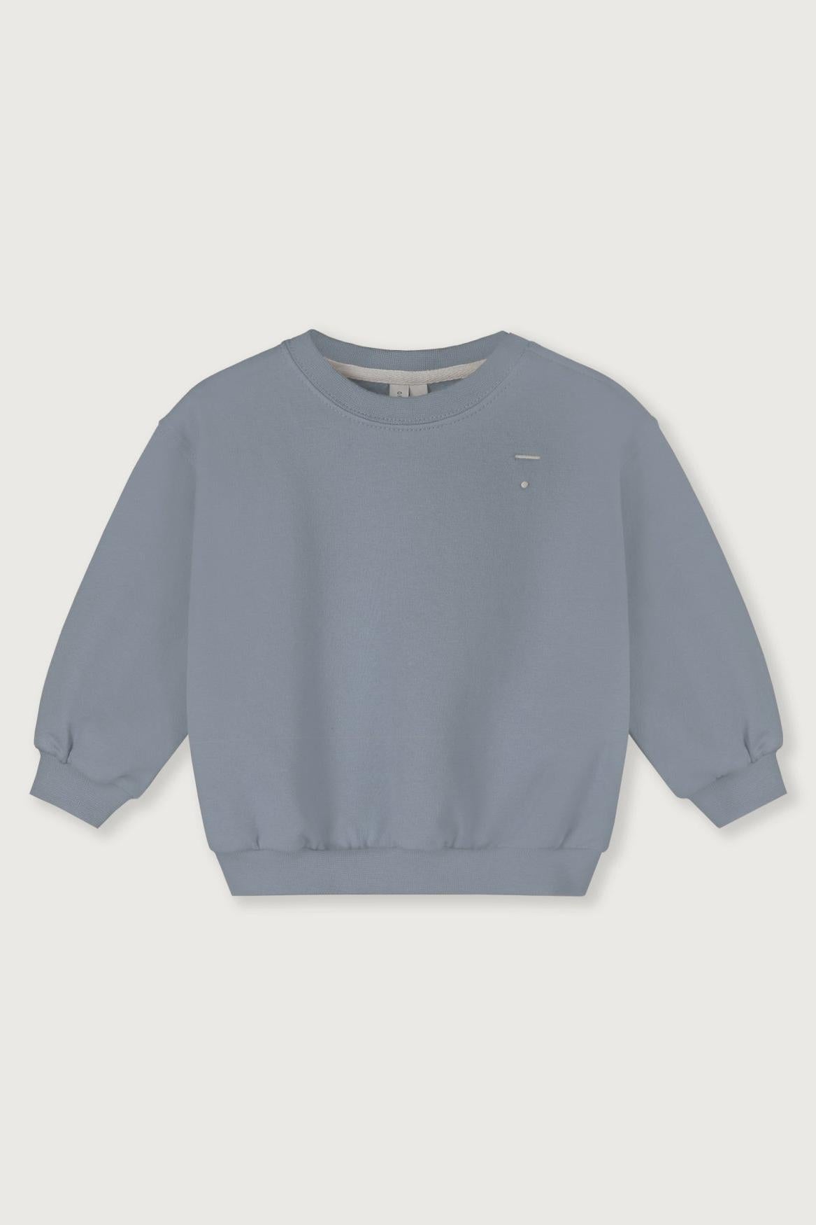 Blue organic cotton sweatshirt on a light gray background
