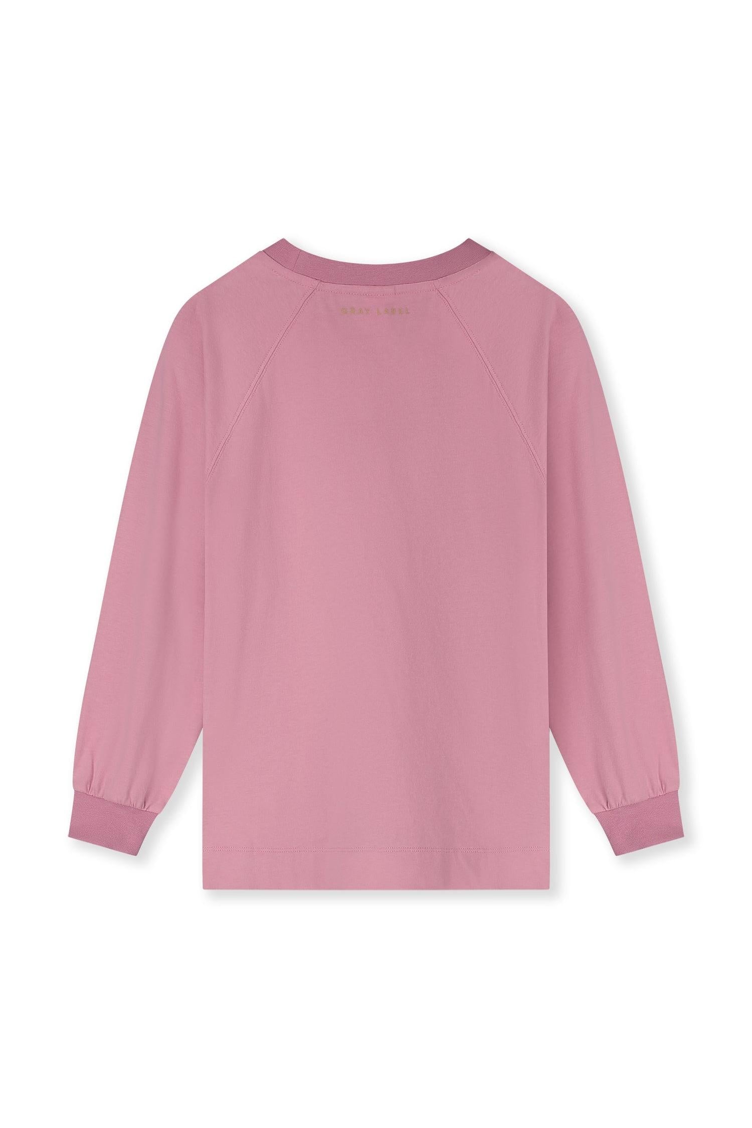 A dusty pink long-sleeve raglan sweatshirt shown from the back, featuring a crew neck, elastic cuffs, and a small gold 'GRAY LABEL' logo printed at the inner neckline, set against a plain white background.