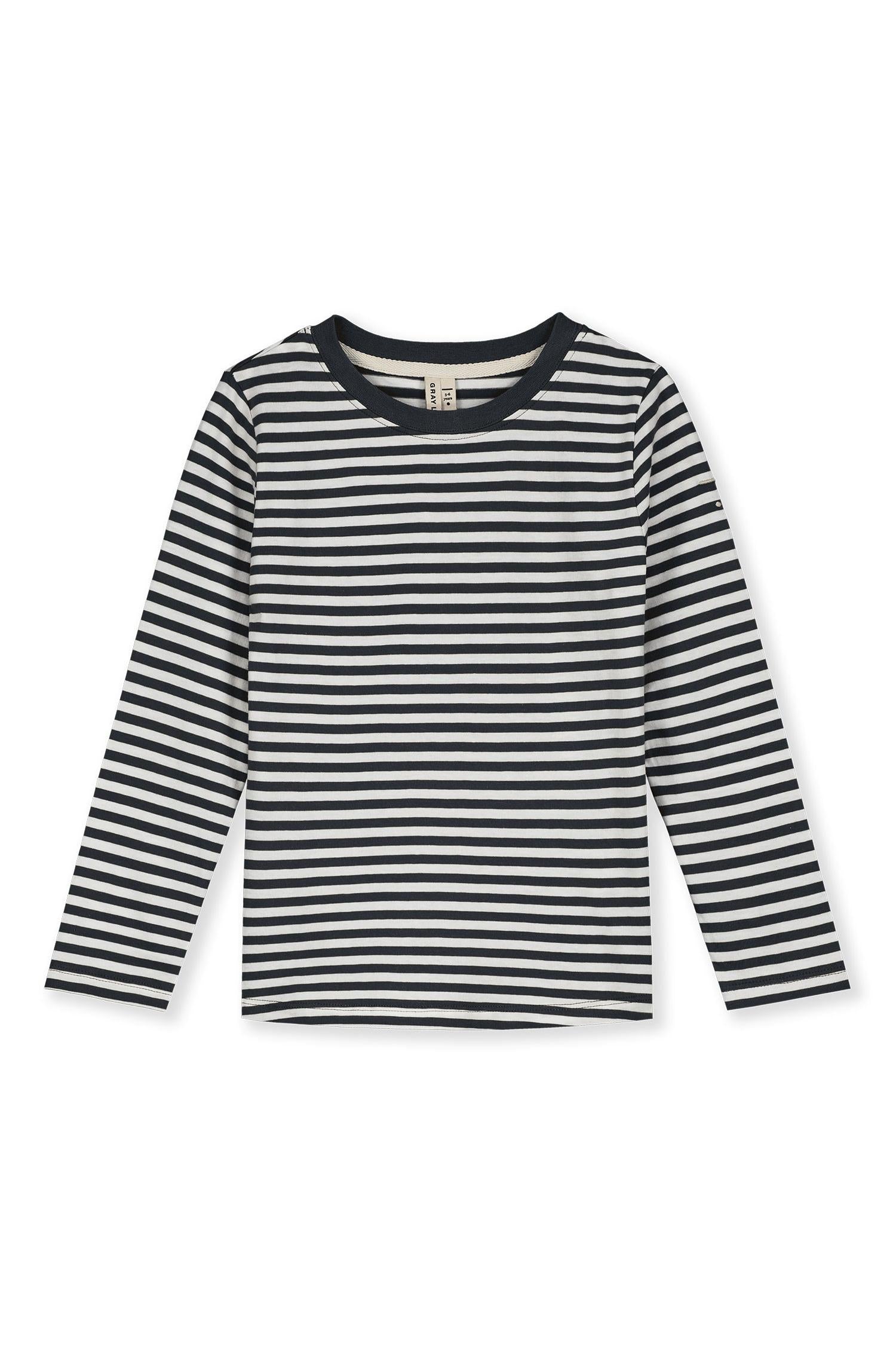 A long-sleeve kids' top with horizontal black and off-white stripes, featuring a solid navy crew neck, displayed flat against a white background.