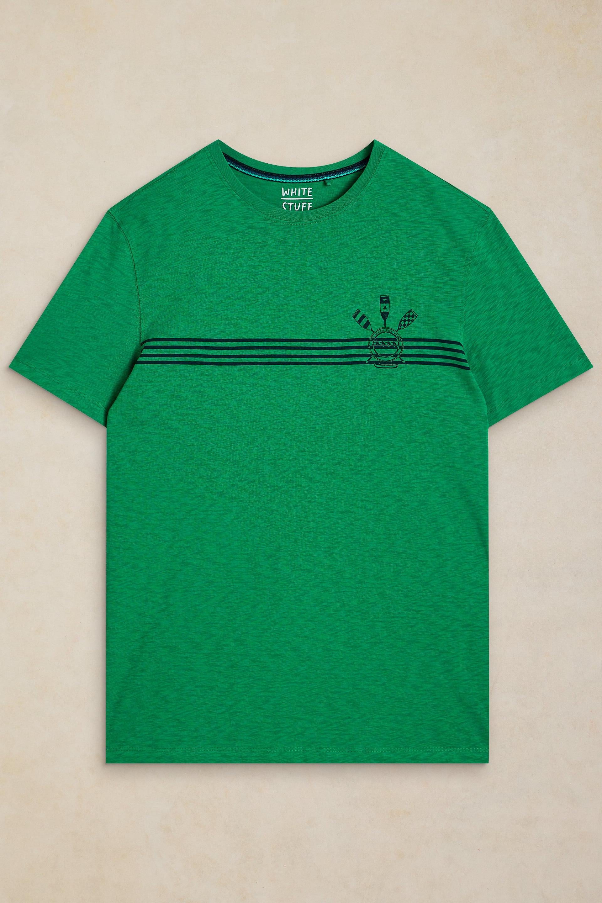 A green short-sleeve crewneck t-shirt with three horizontal black stripes across the chest and a small black graphic on the left chest, displayed flat against a light beige textured background.
