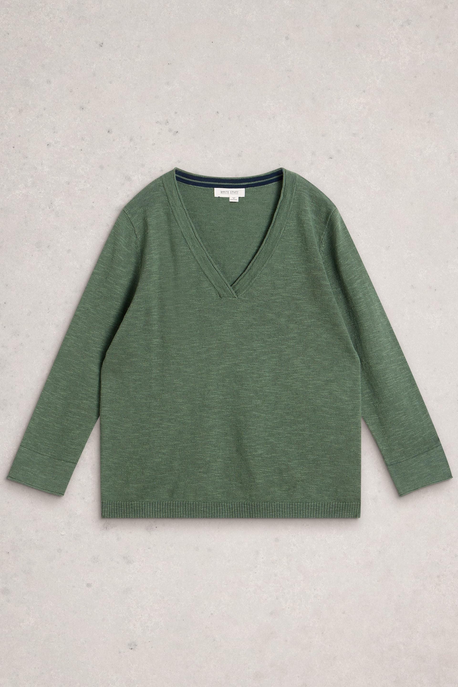 A sage green V-neck organic cotton sweater by White Stuff on a light textured background.