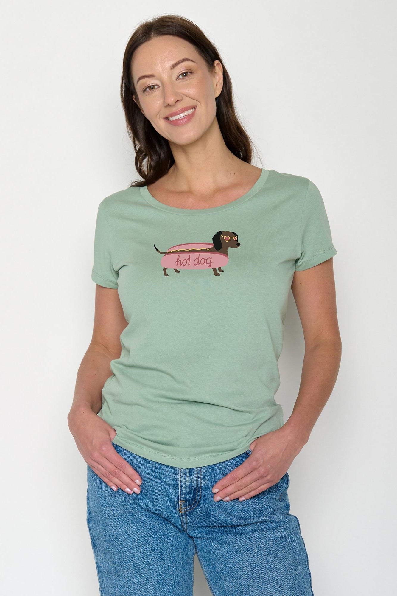 Woman wearing a green organic cotton t-shirt with a dog graphic and text on a white background