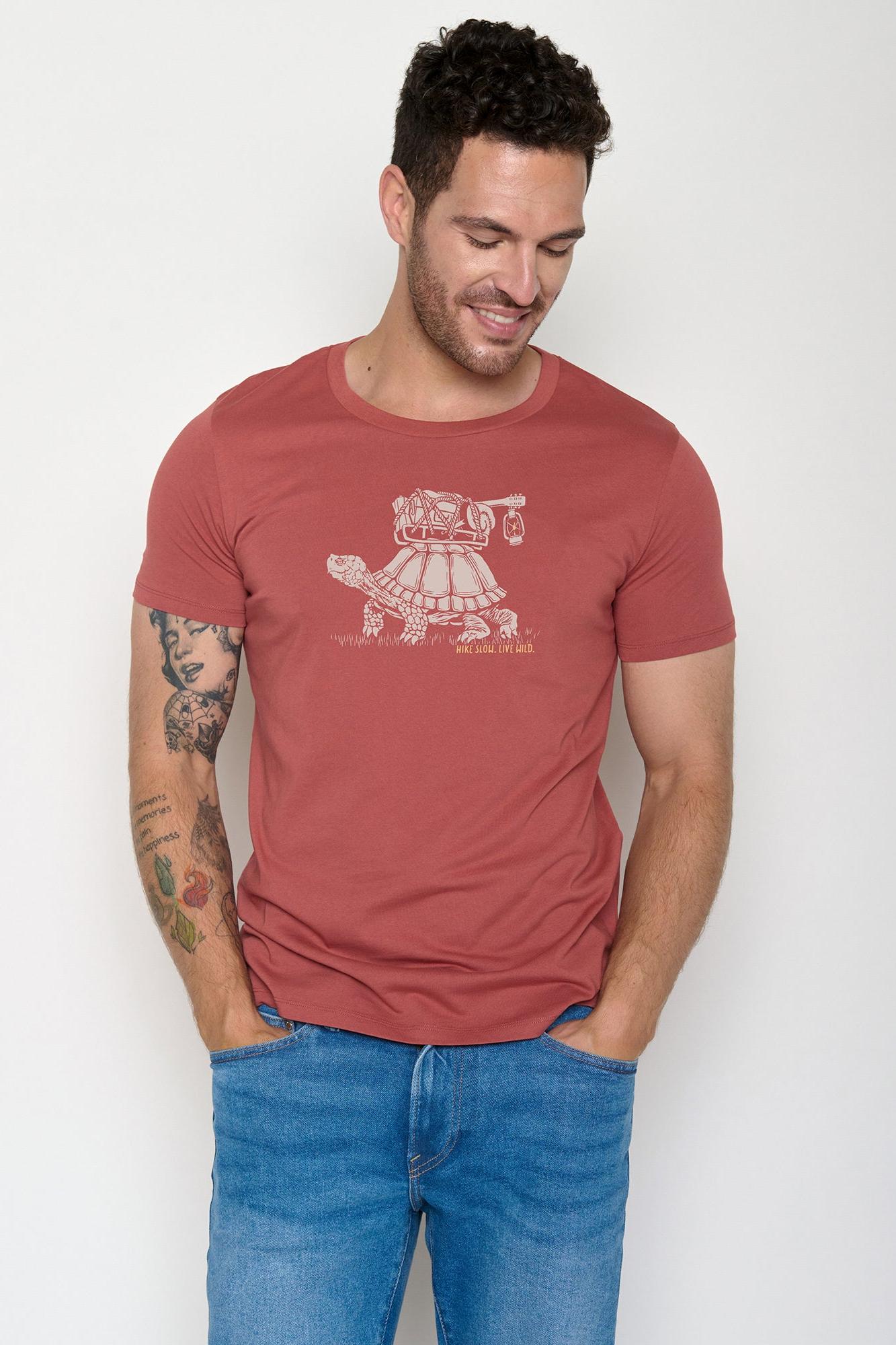 Man wearing a red organic cotton t-shirt with a graphic design on a white background