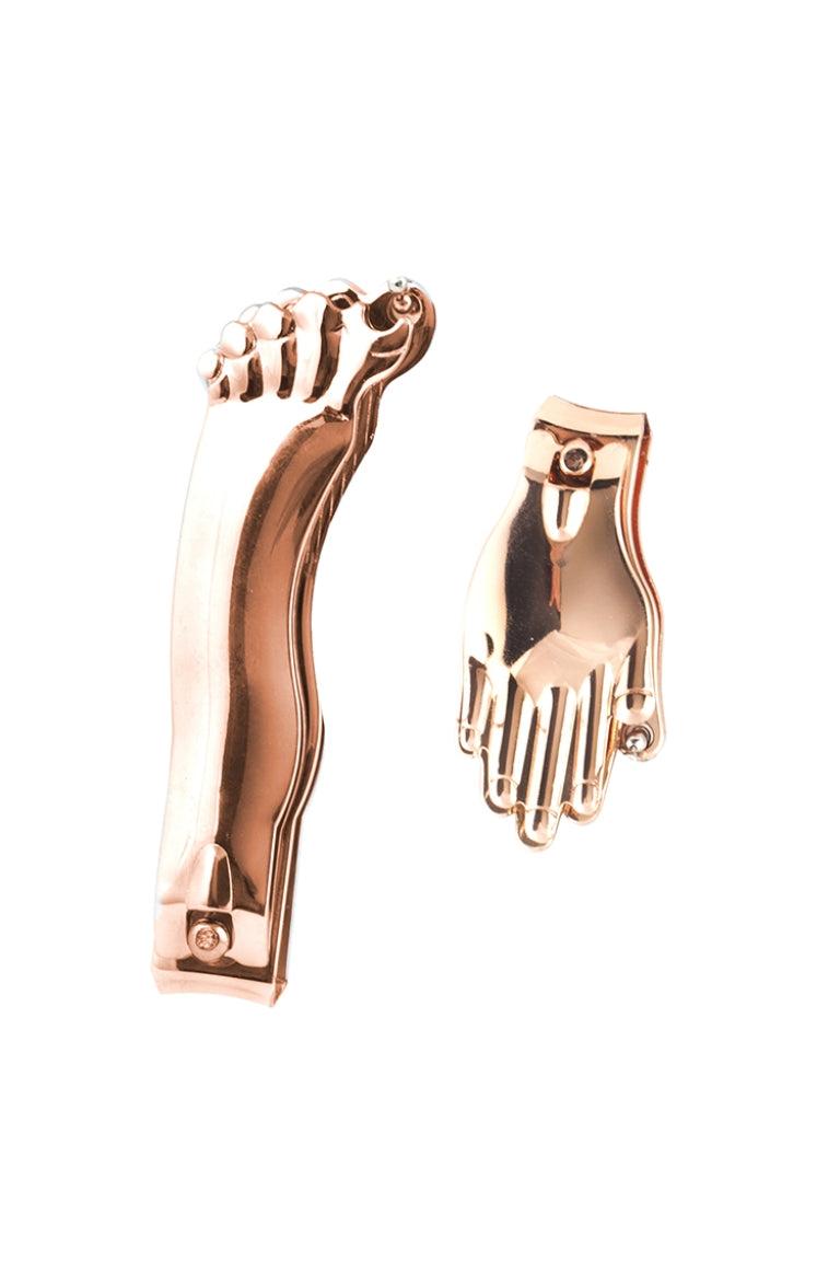 copper foot and hand-shaped earrings on a white background