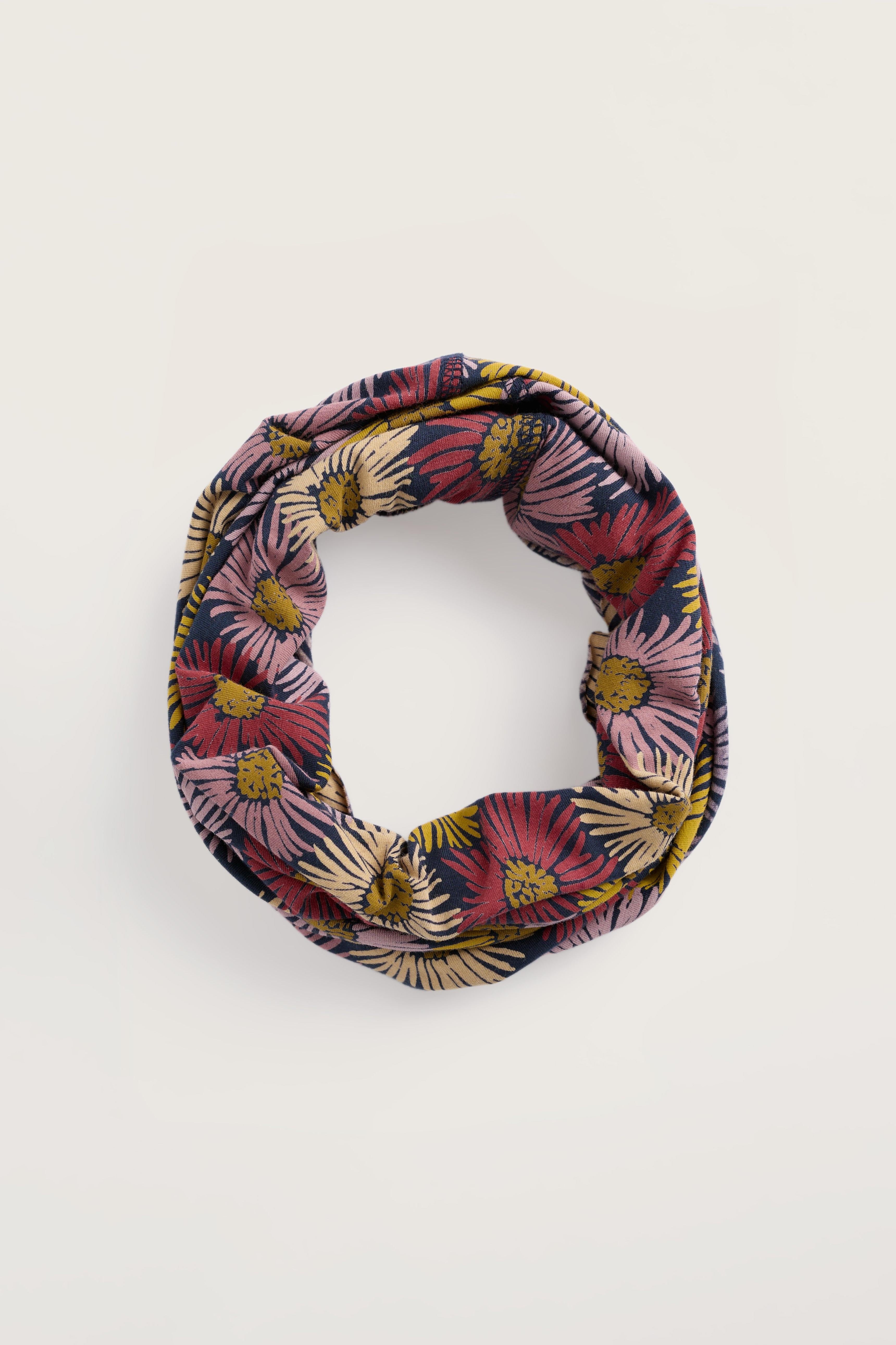 Floral patterned infinity scarf on a white background