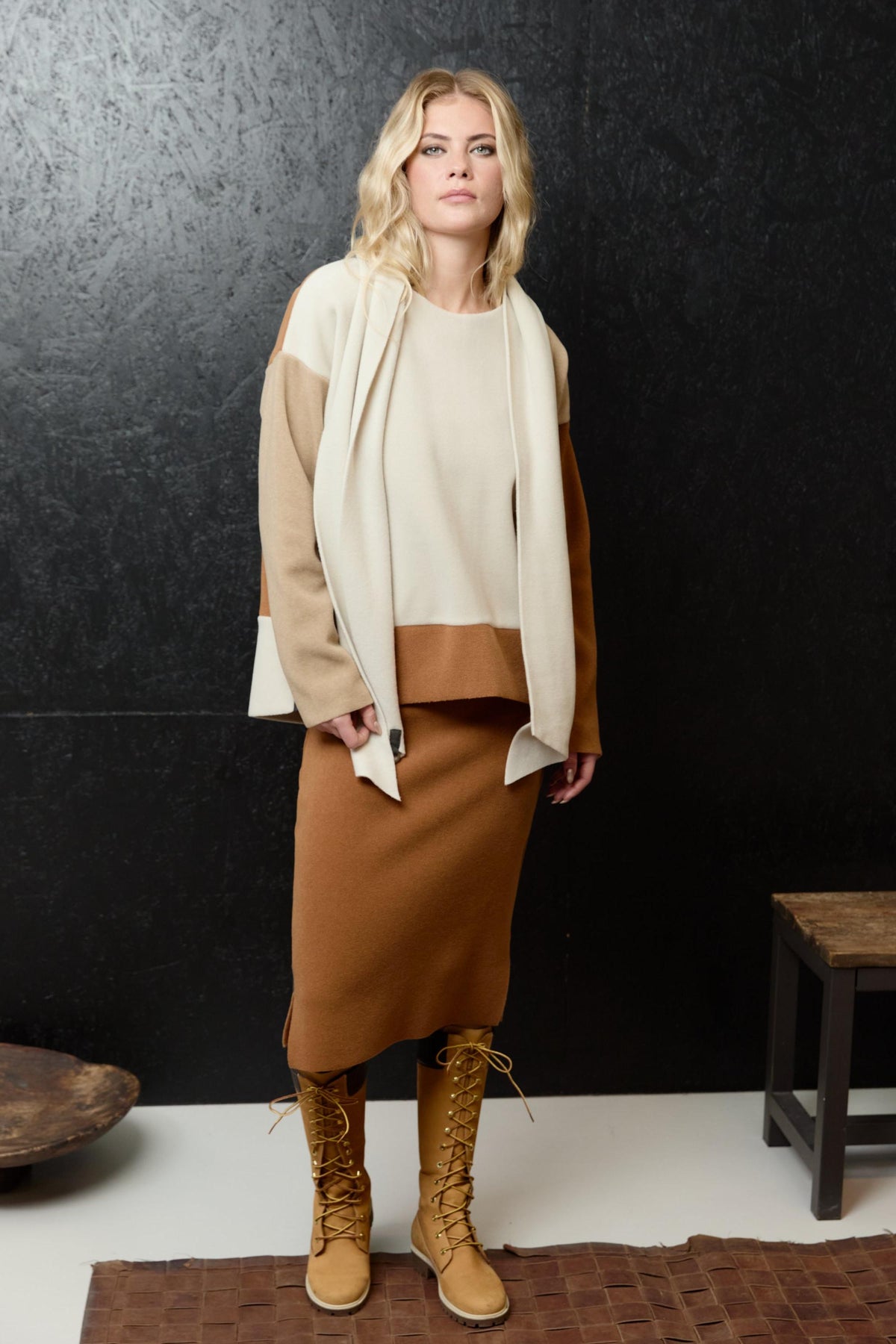 A woman modeling a sustainable Henriette Steffensen fleece two-piece set in neutral tones.