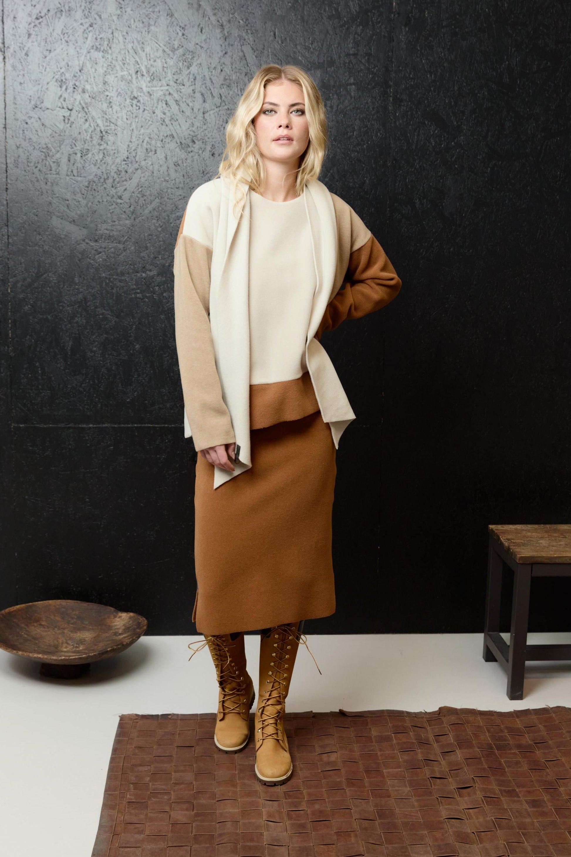Blonde woman wearing a sustainable Henriette Steffensen fleece top and matching brown skirt.
