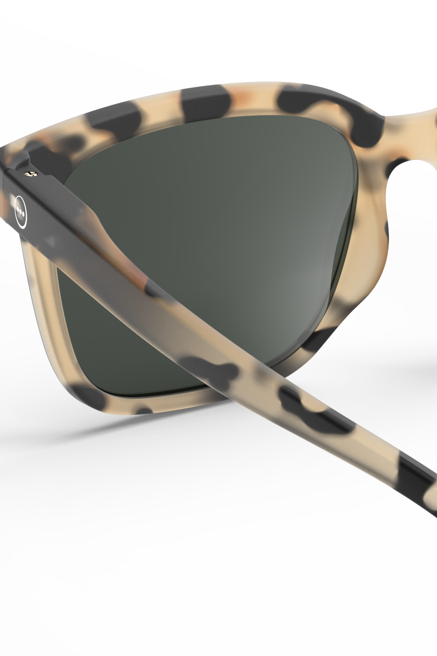 Close-up of Izipizi tortoiseshell pattern sunglasses against a white background.