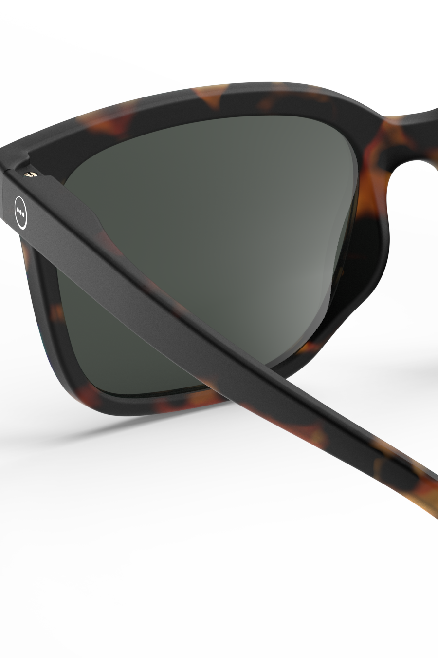 Close-up of Izipizi tortoiseshell frame sunglasses with green lenses against a clean white background.