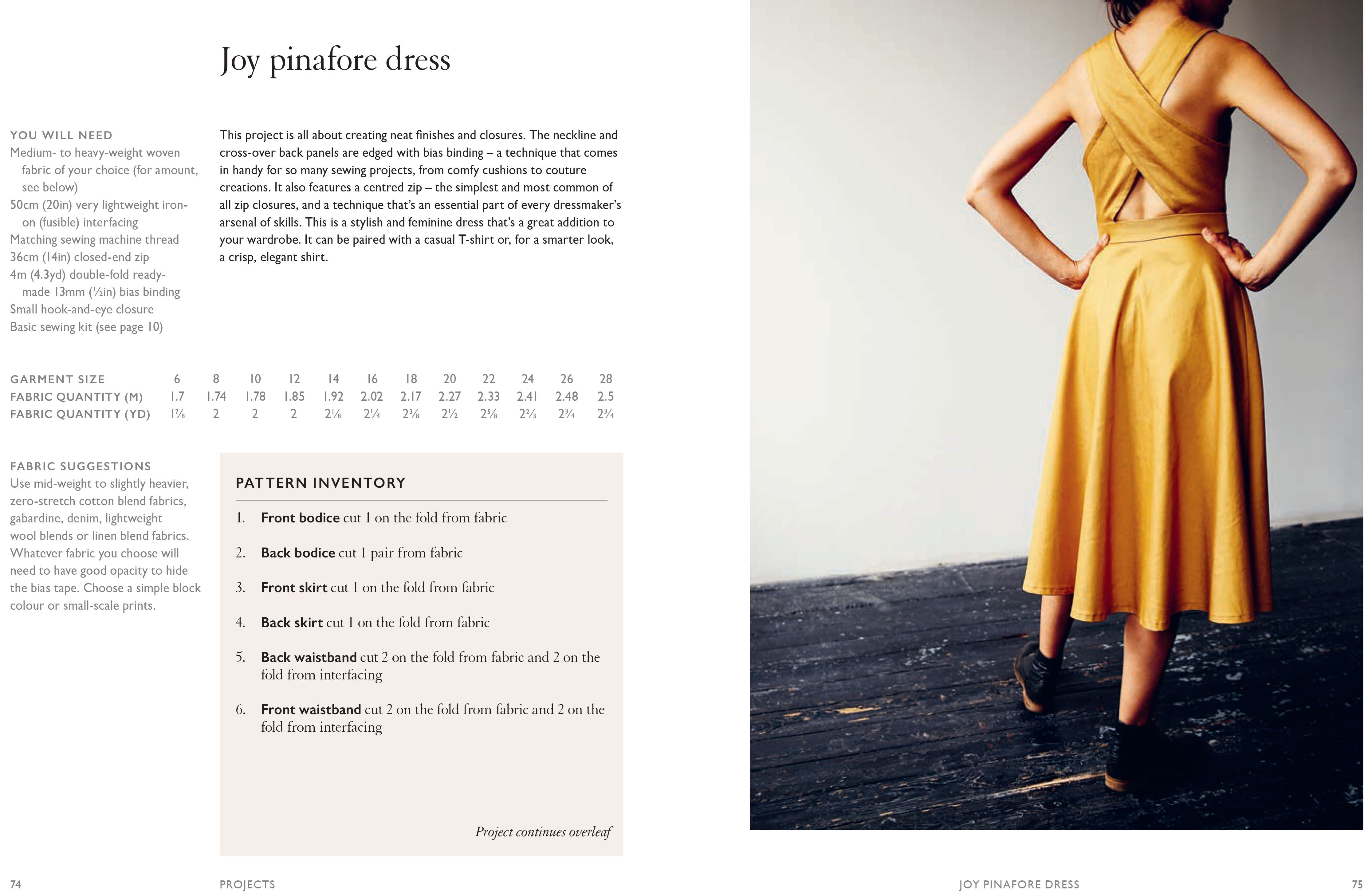 Back view of a woman wearing a mustard yellow handmade pinafore dress with a cross-over back design