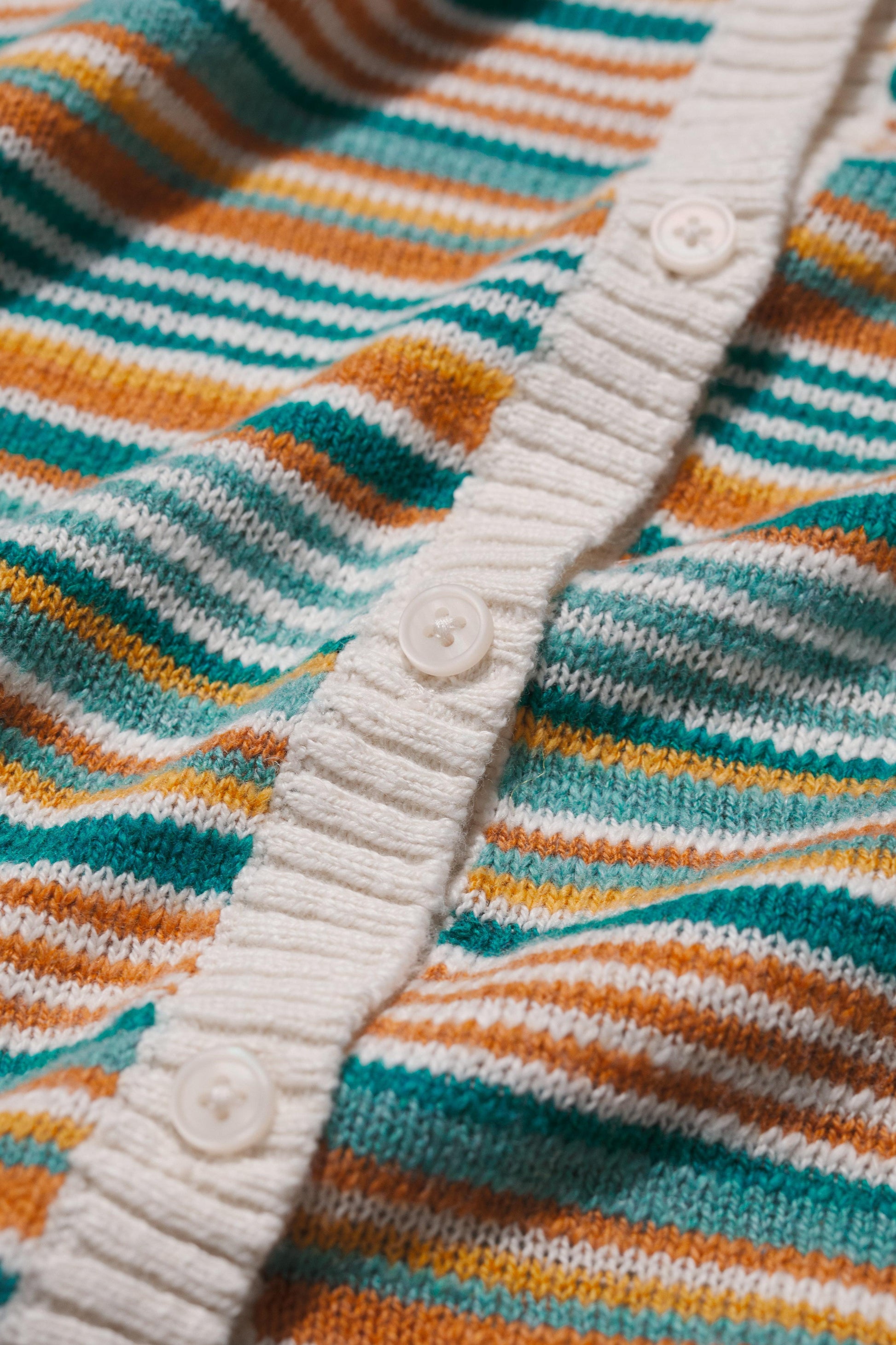 Close-up of a striped sweater with buttons 