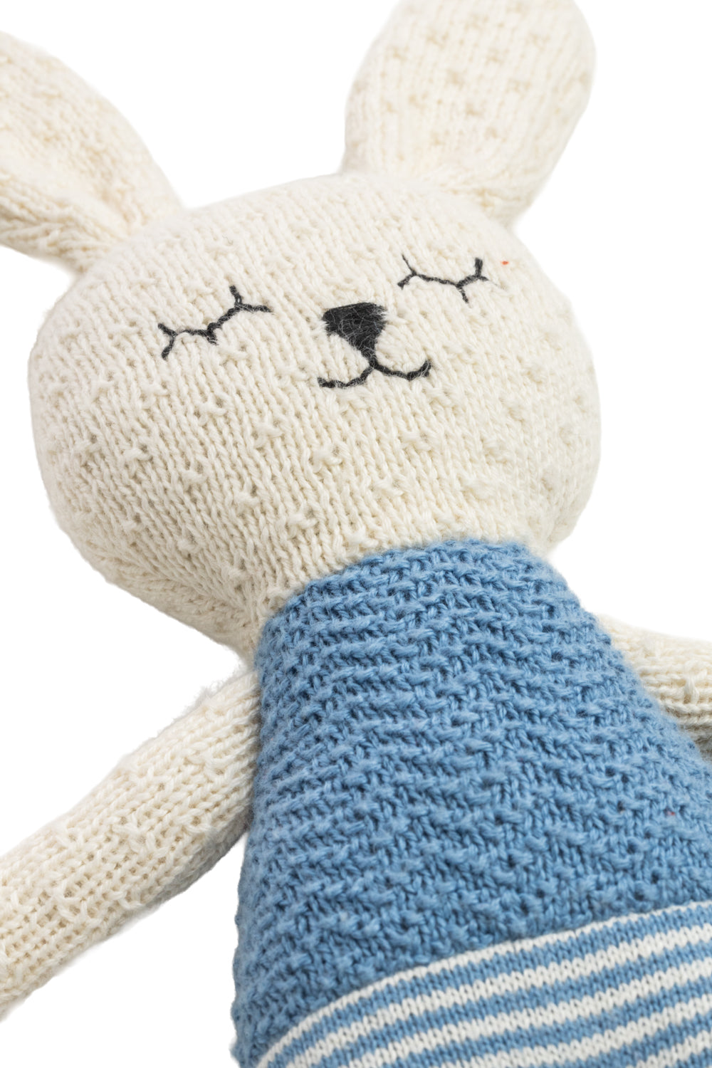 Knitted toy rabbit with a blue top on a white background