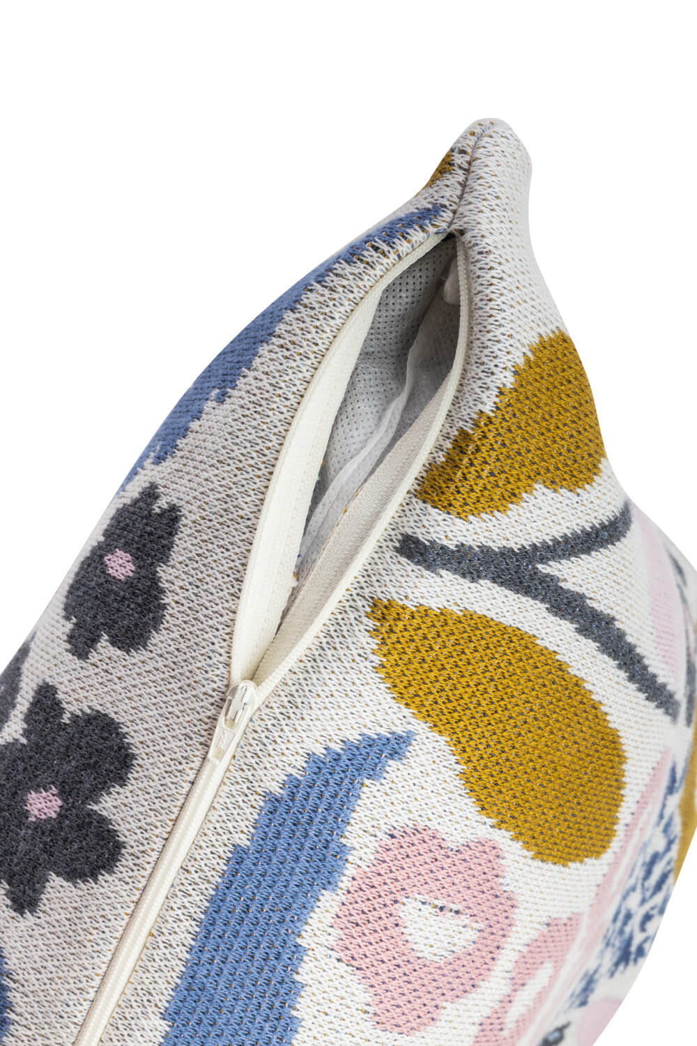 Close-up of a floral pattern knitted organic cotton pillow cover showing the zipper detail.