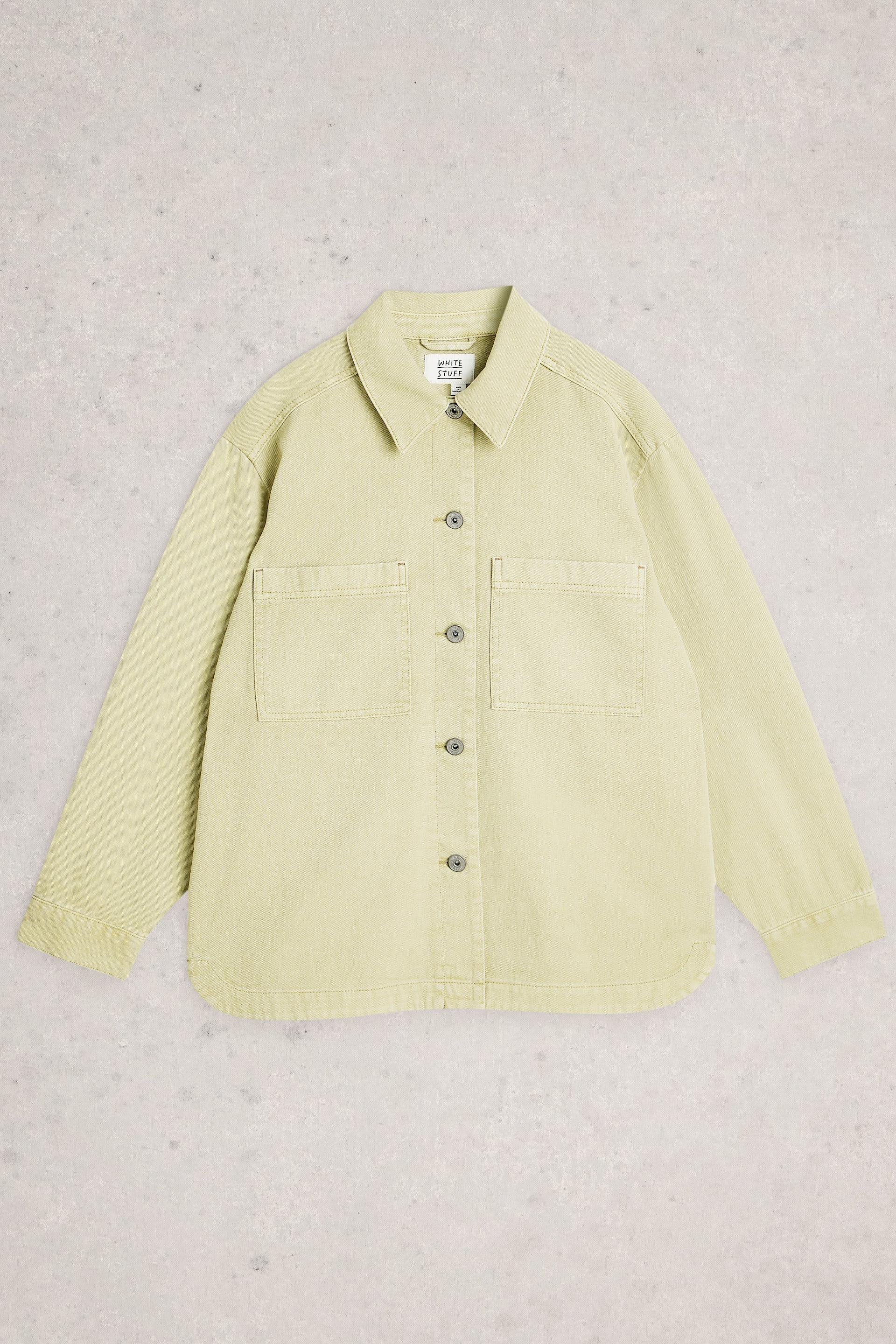 Light green shirt on a textured beige background