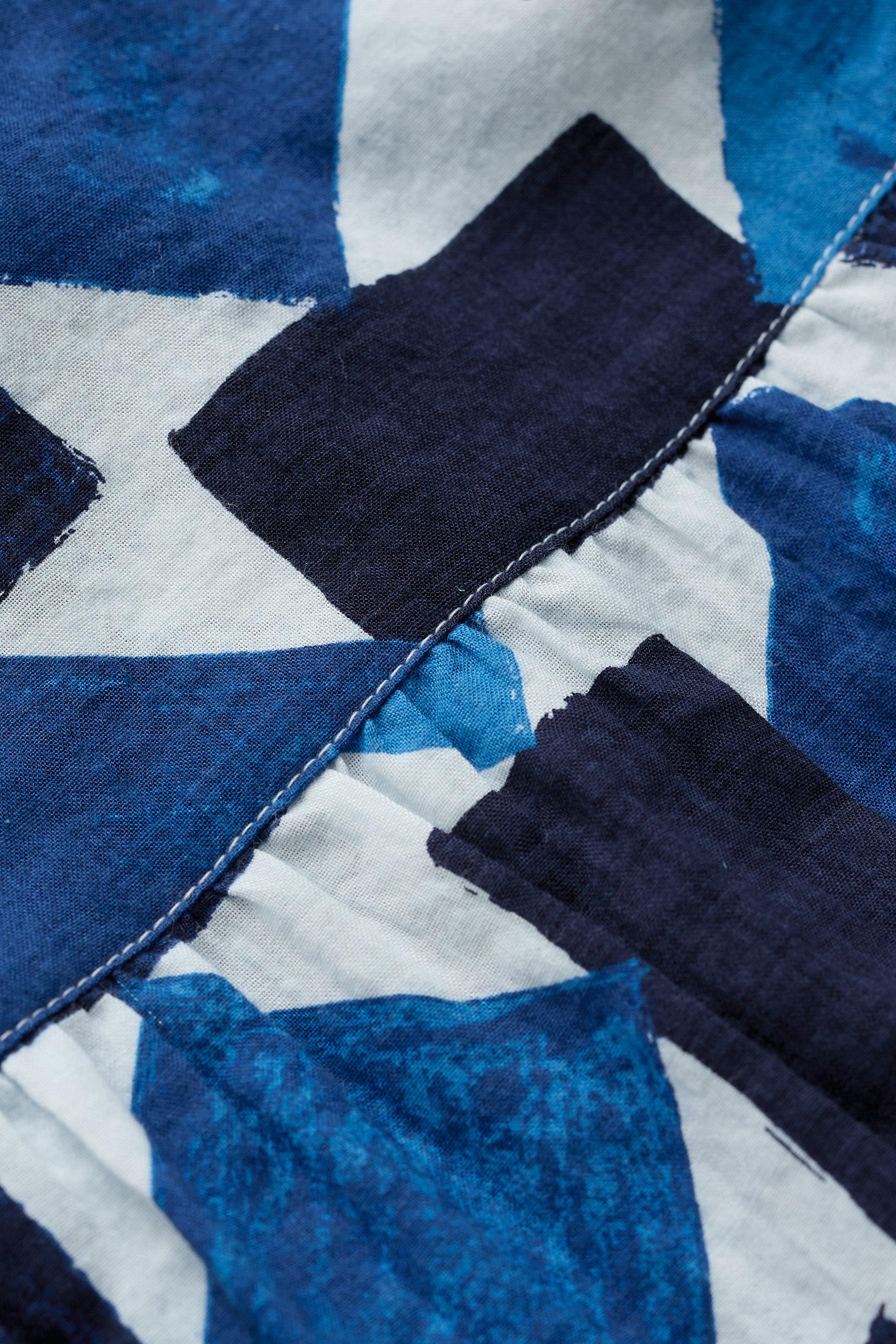 Close-up of an organic cotton shirt with blue and black geometric pattern