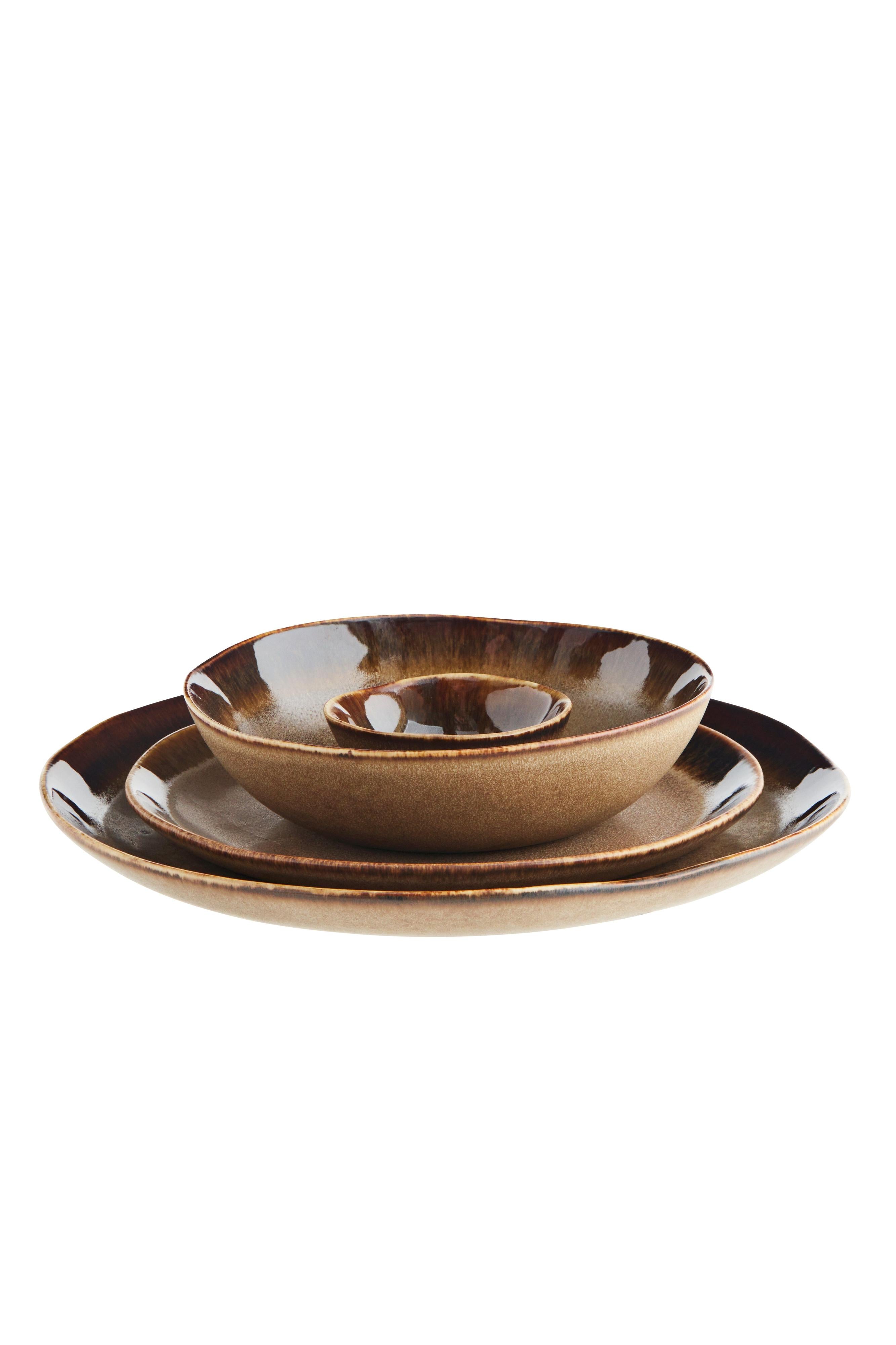 Set of brown ceramic plates on a white background