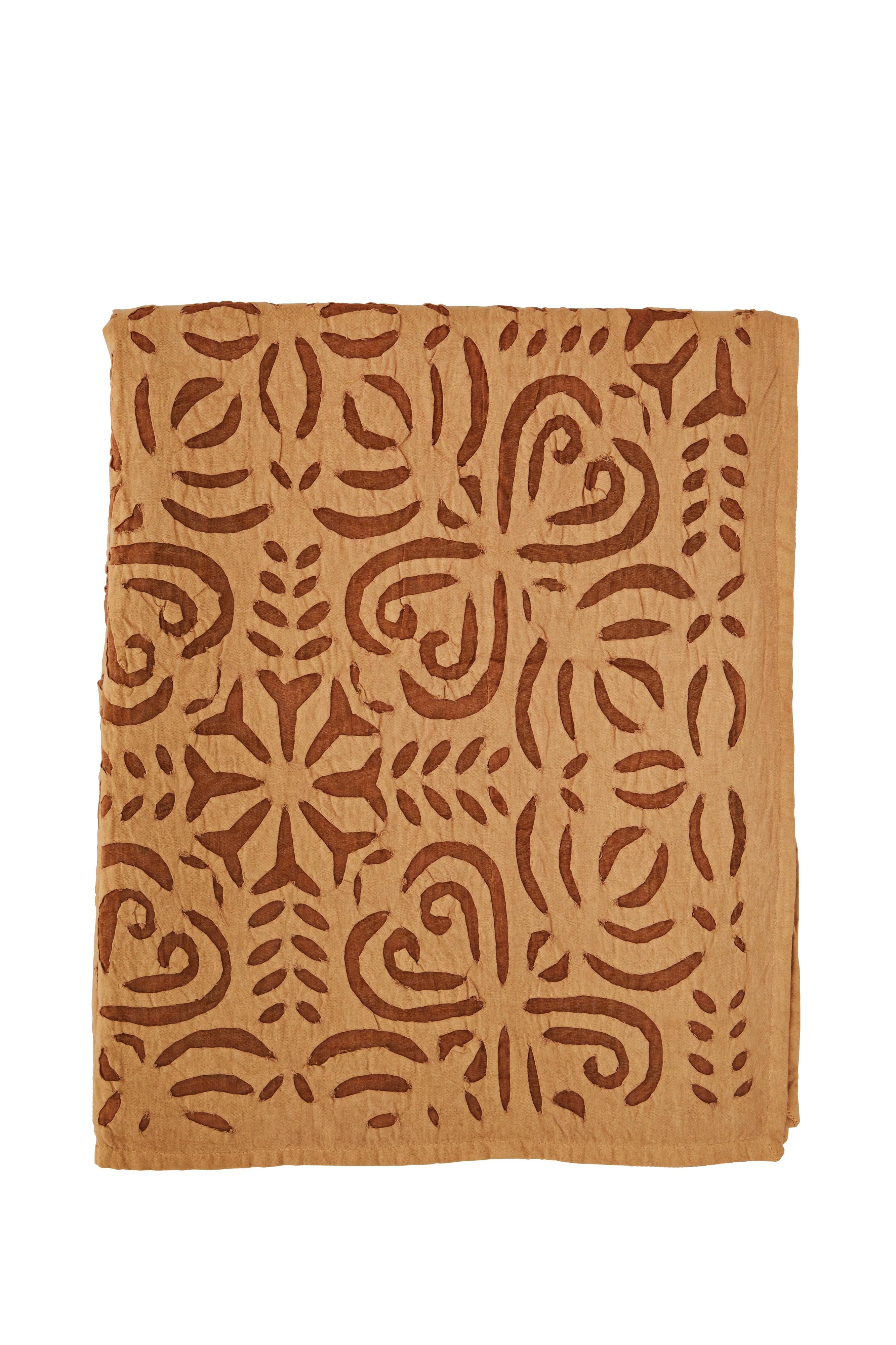 Brown fabric with intricate pattern on a white background