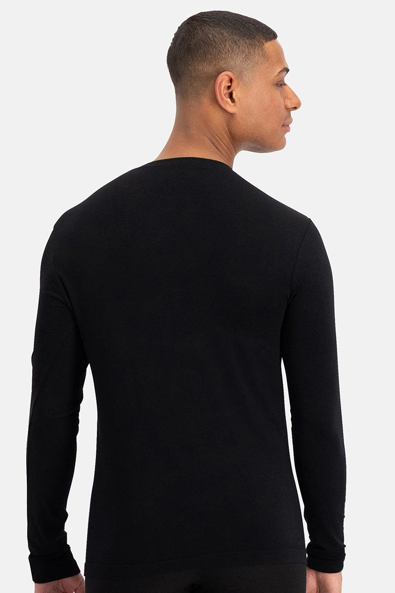 A man viewed from behind wearing a plain black long-sleeve bamboo fabric shirt against a white background