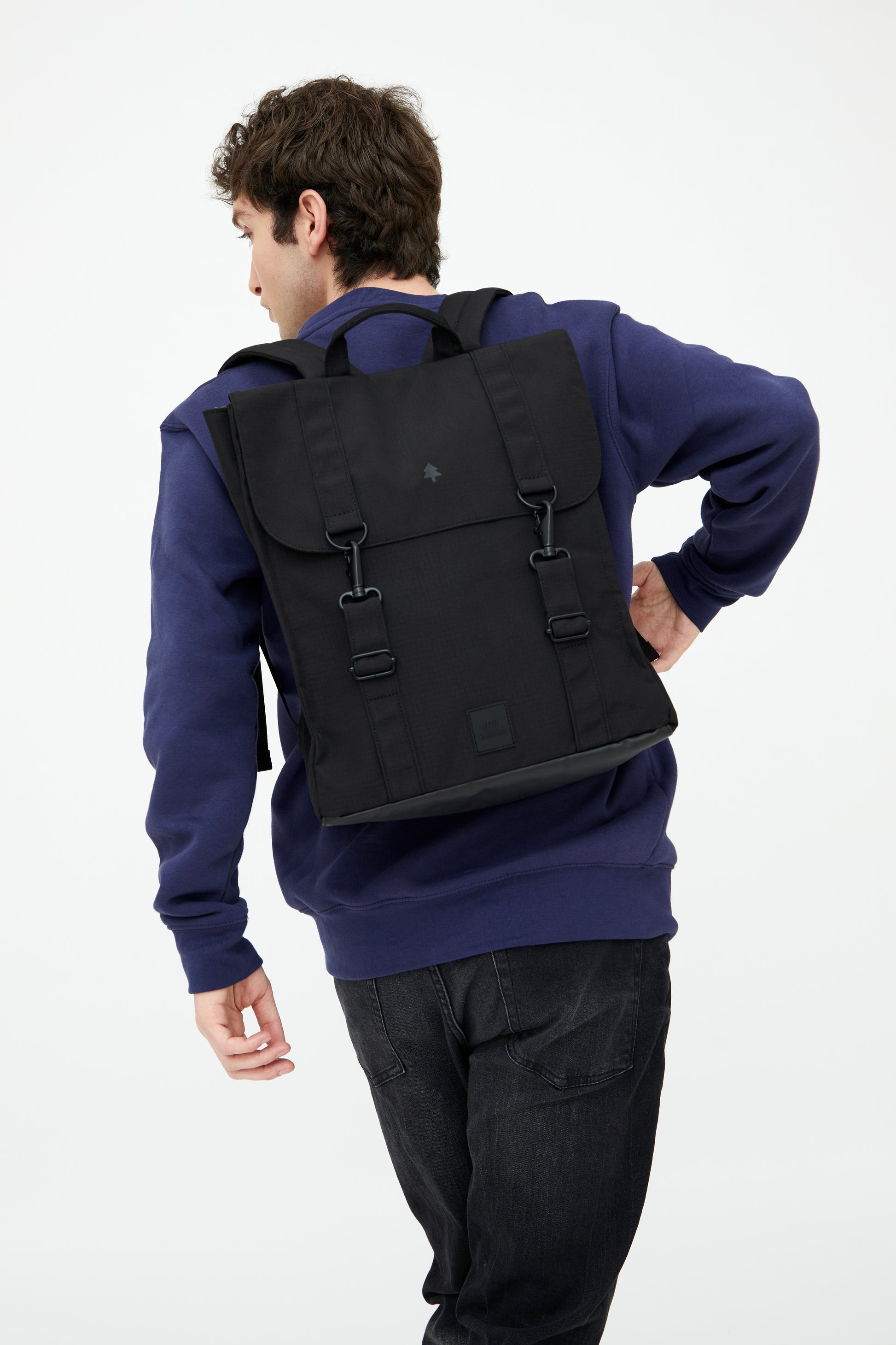 Person wearing a black backpack on a white background
